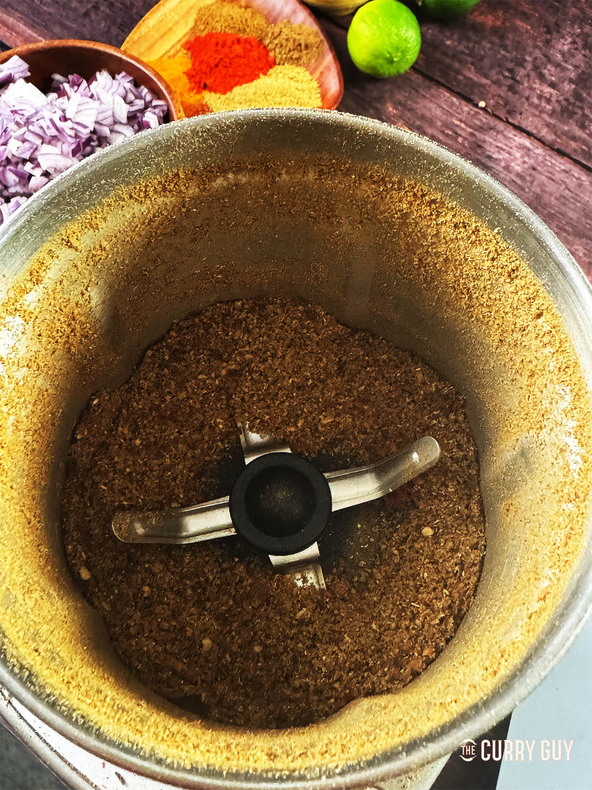 Grinding the whole spices into a fine powder.