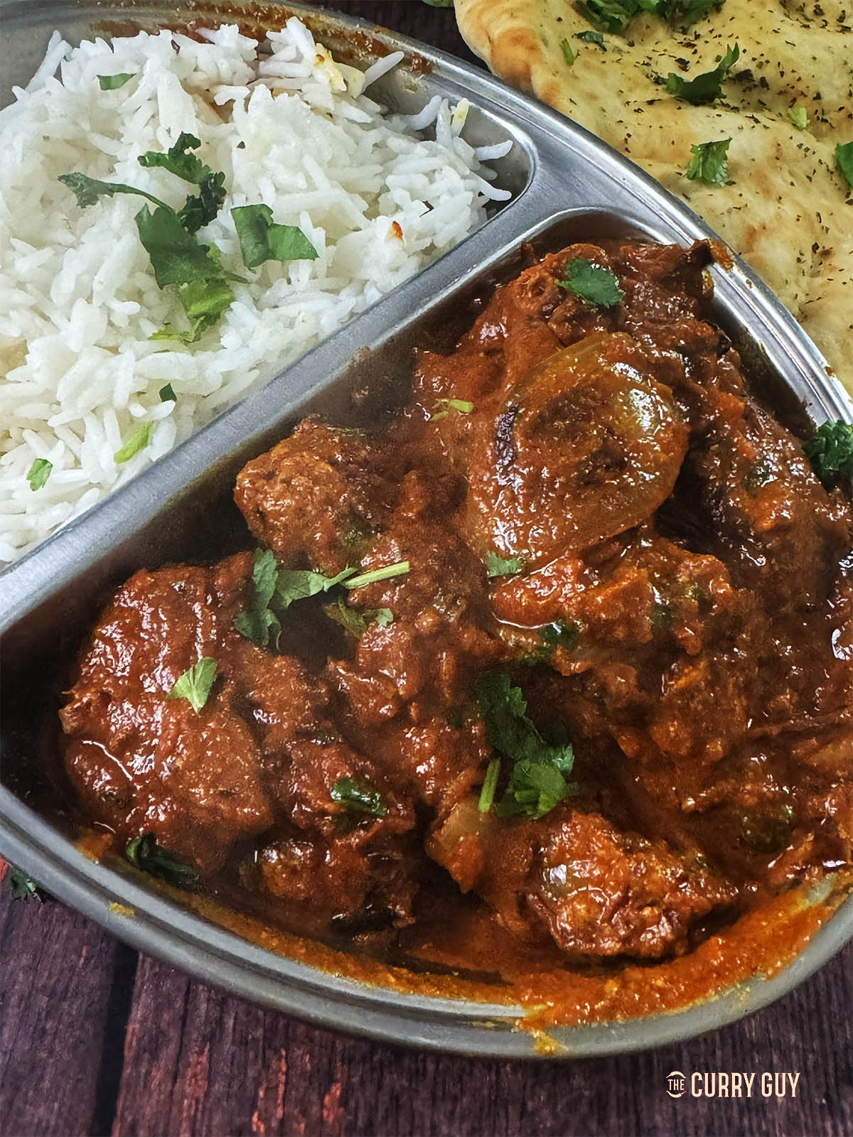 Chicken Do Pyaza served on a plate with rice.