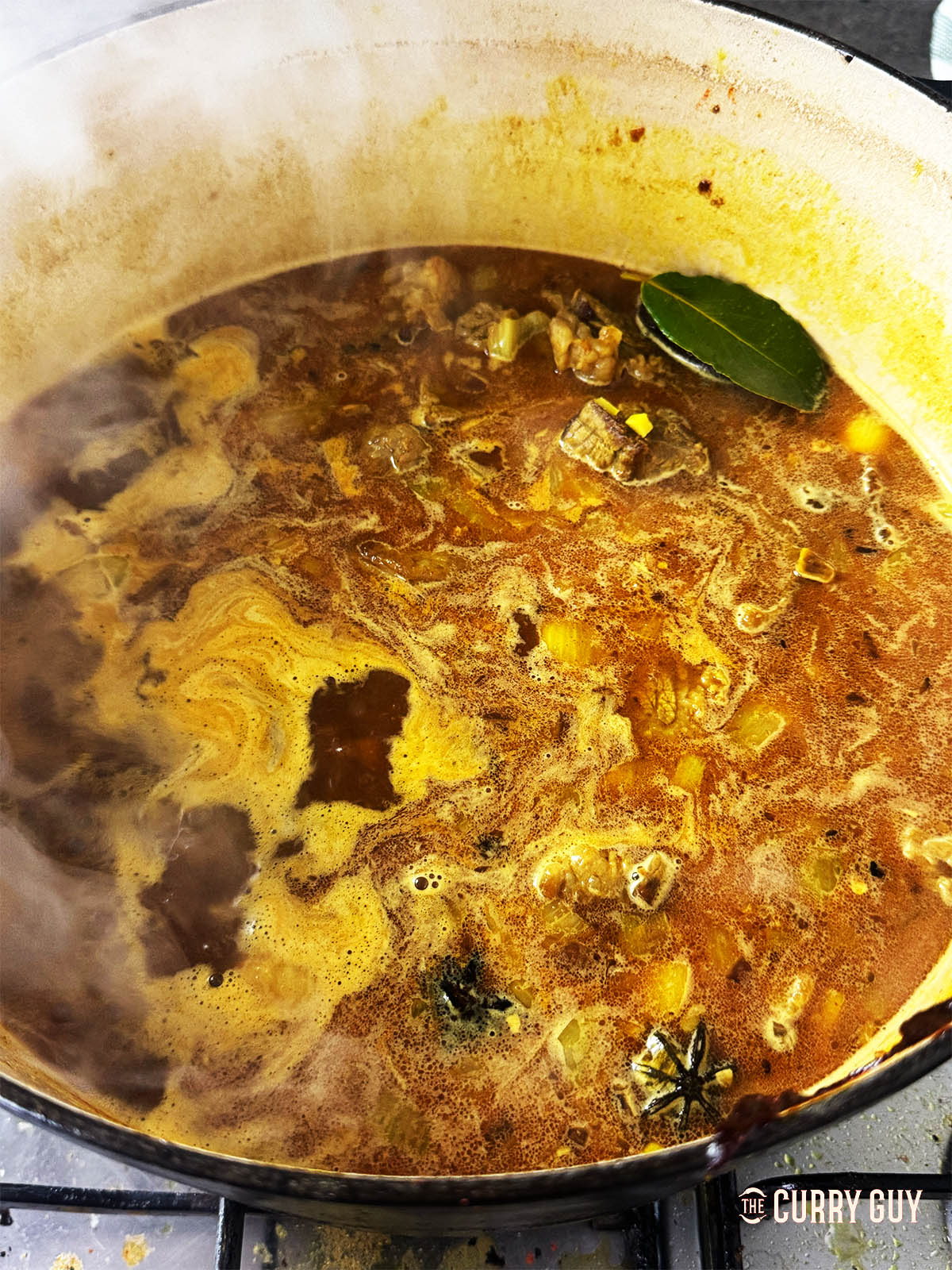 Simmering the curry until the beef is tender.