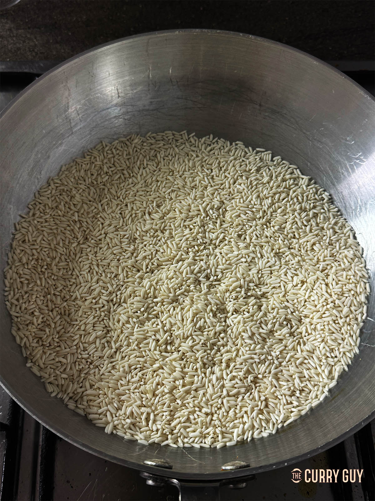 The glutinous rice in a dry frying pan over a medium heat. 