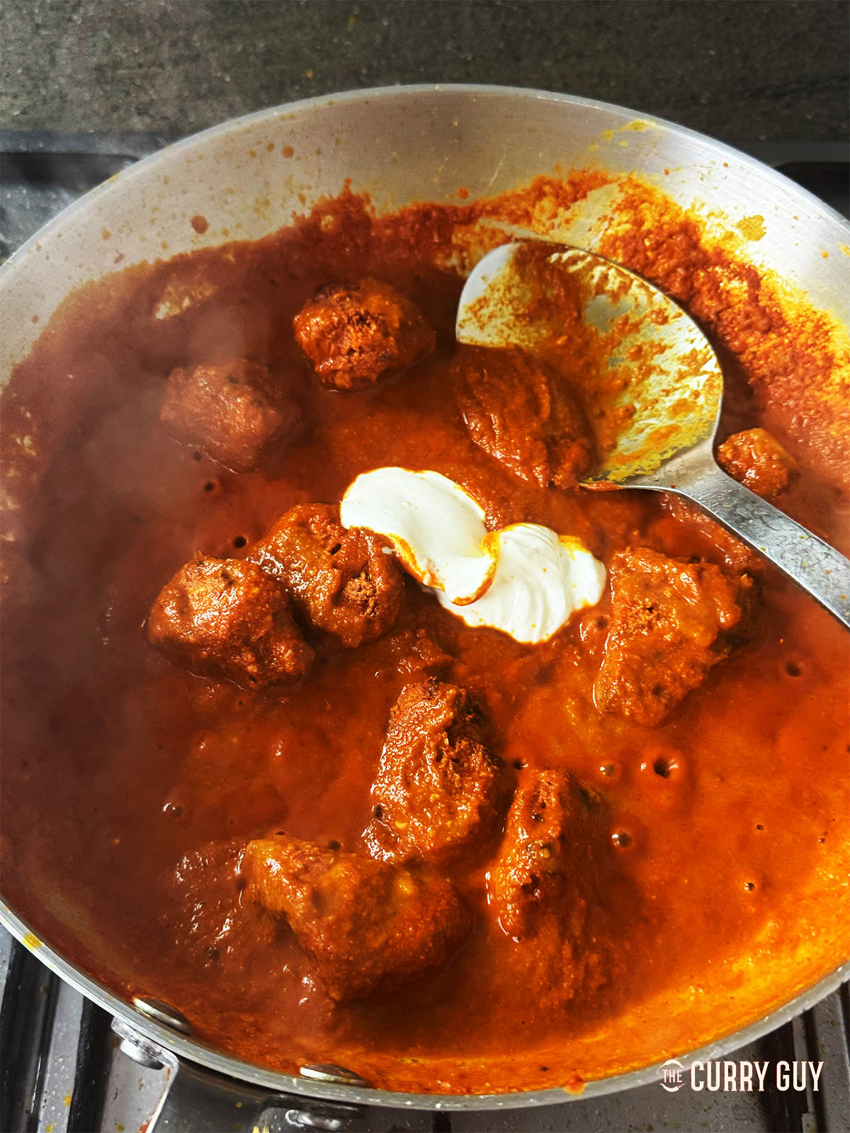 Beginning to add the yoghurt one tablespoon at a time.