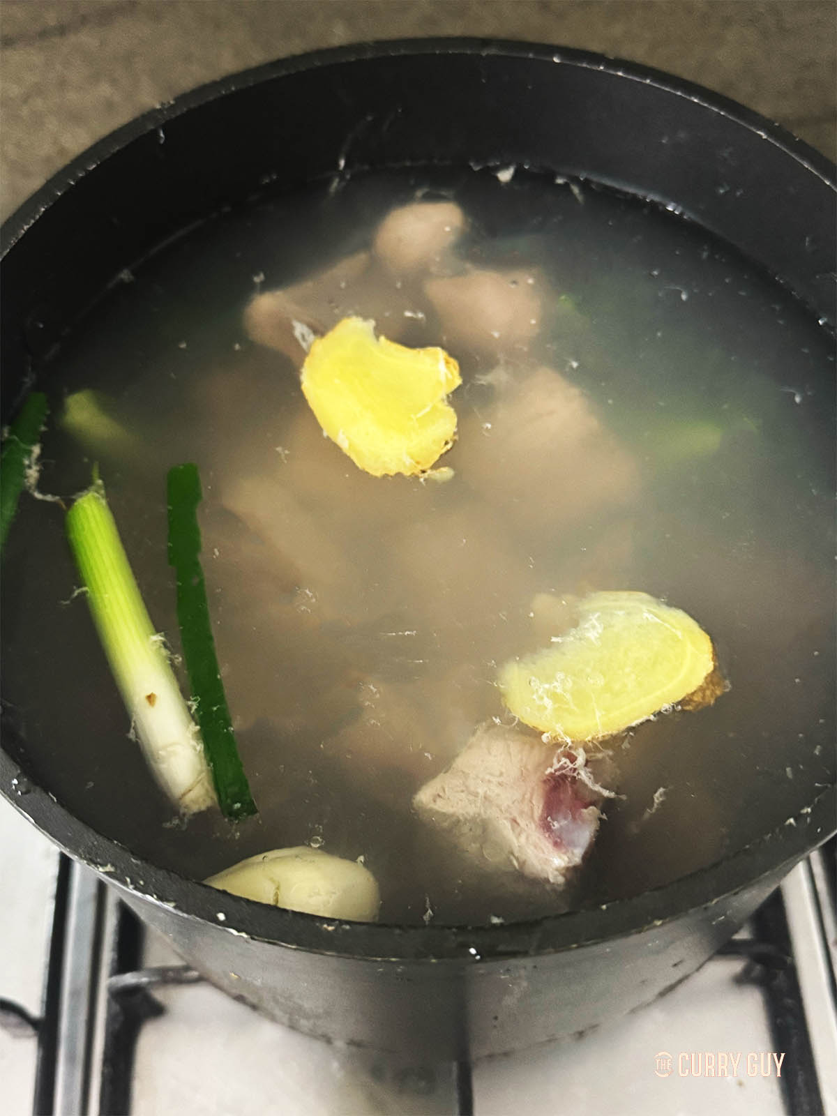 Bringing the ribs and aromatics to a simmer to tenderise the meat.