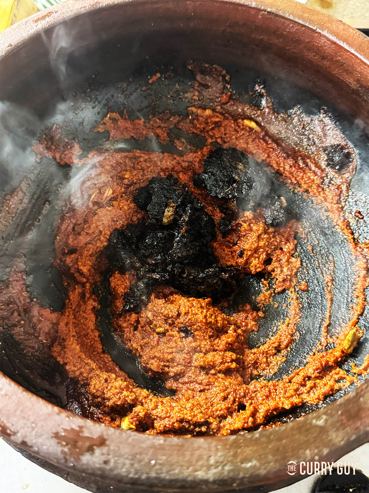 Stirring the onion paste into the pot.
