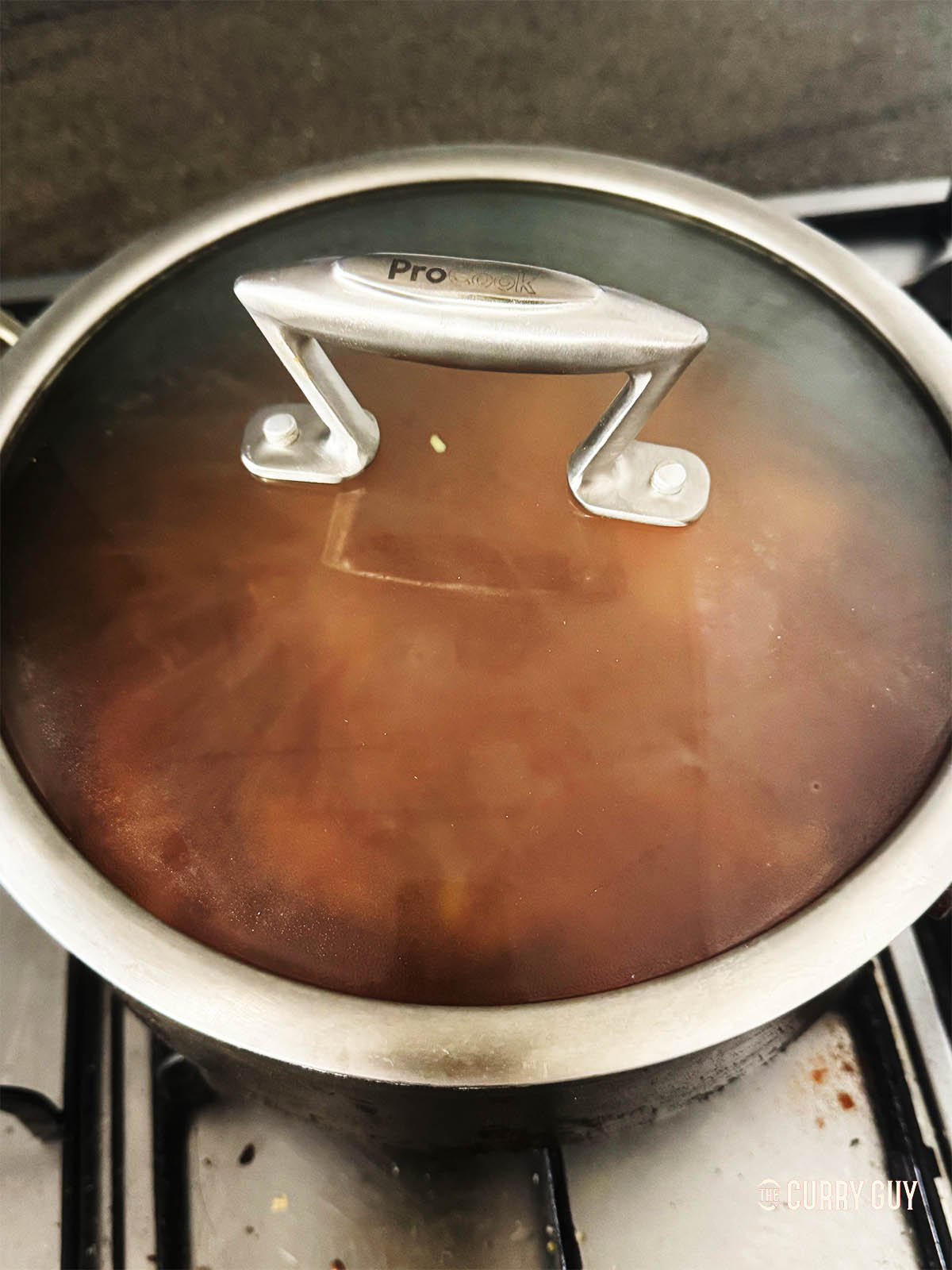 Covering the pan to simmer.