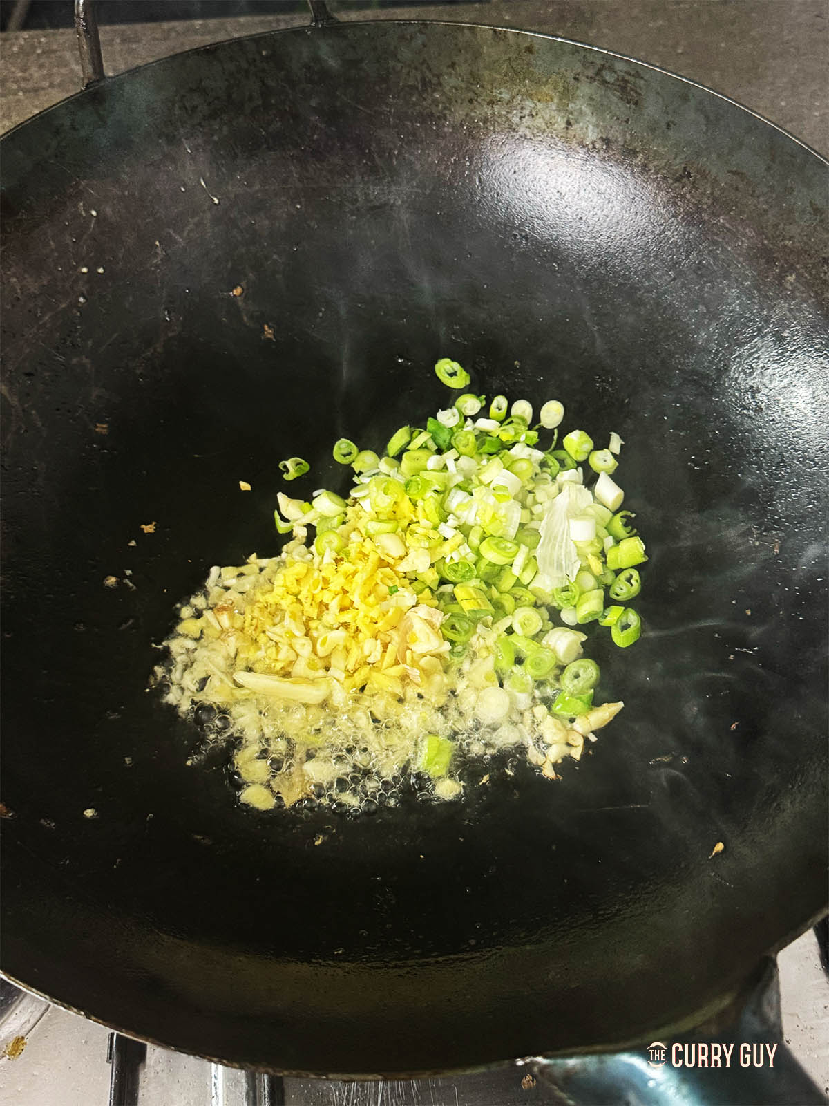 Frying garlic, ginger and spring onions (scallions)
