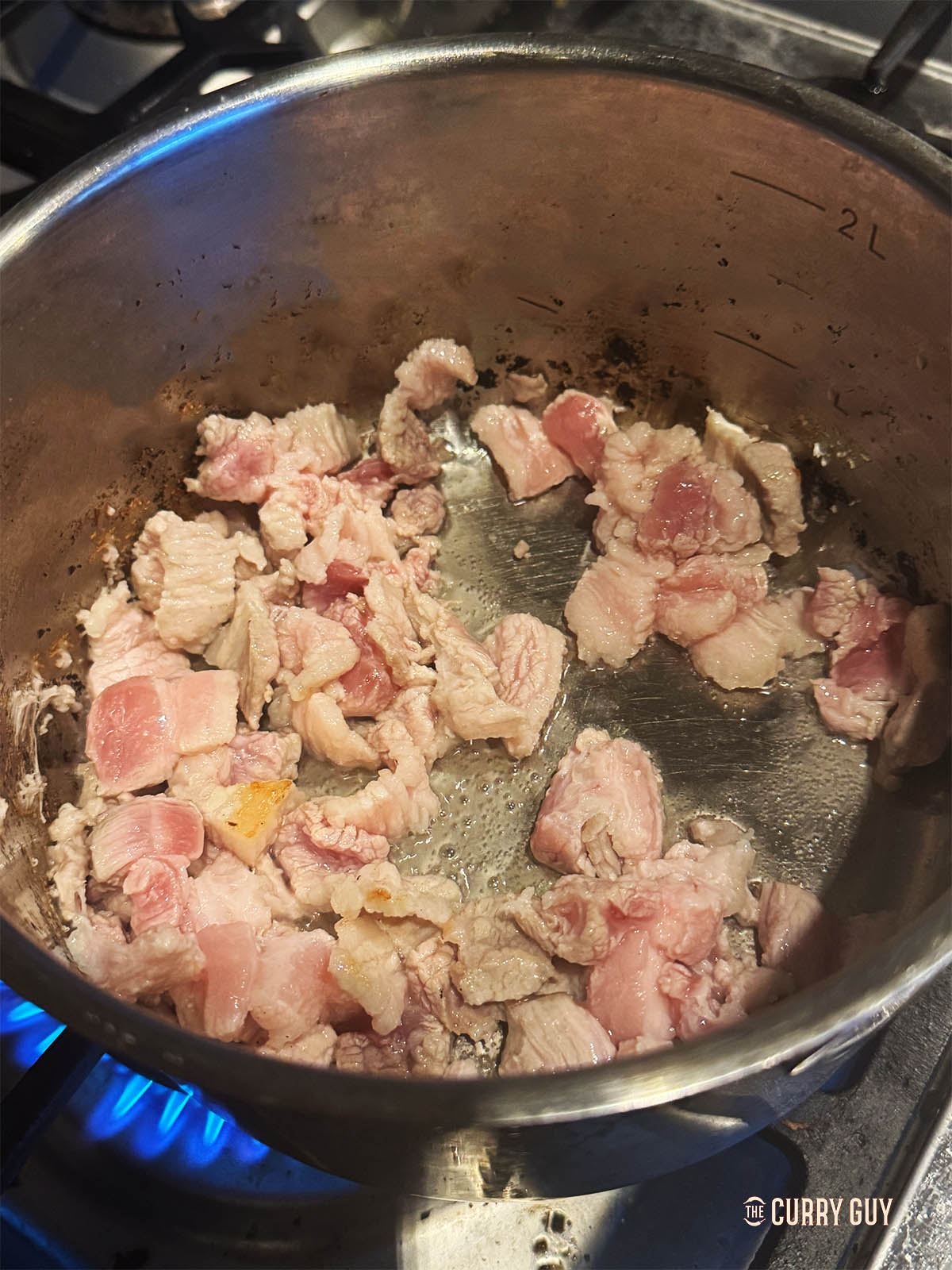Frying the pork belly in pork lard to sear.