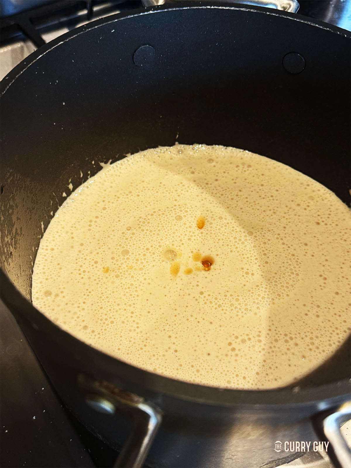 The blended tonkotsu broth with added soy sauce in a sauce pan. 