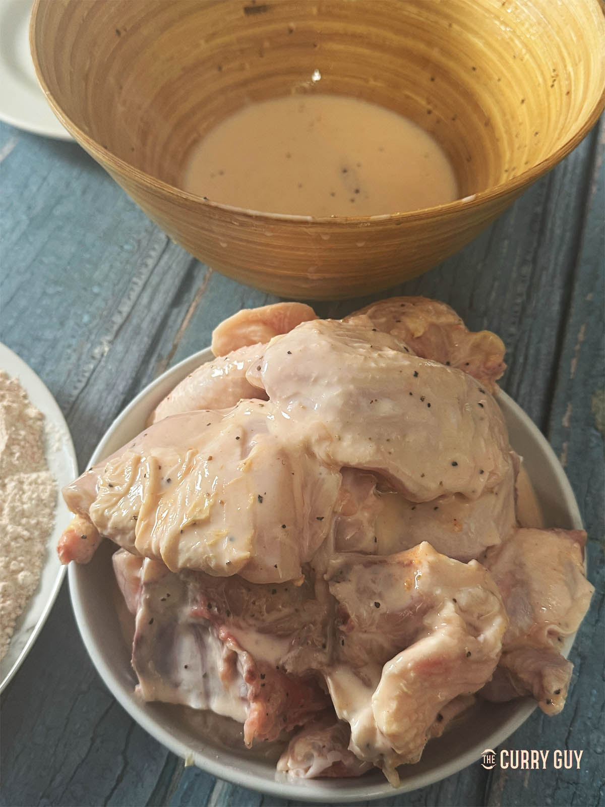 Removing the chicken from the spice and butter milk marinade.