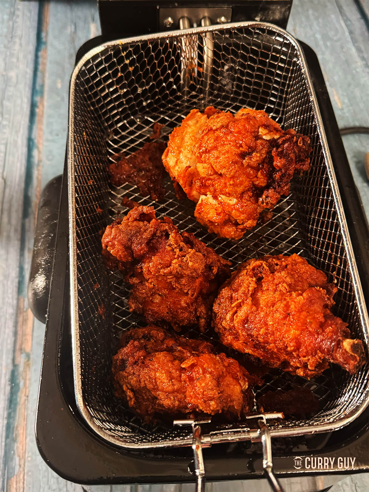 The fried chicken hot out of the oil.