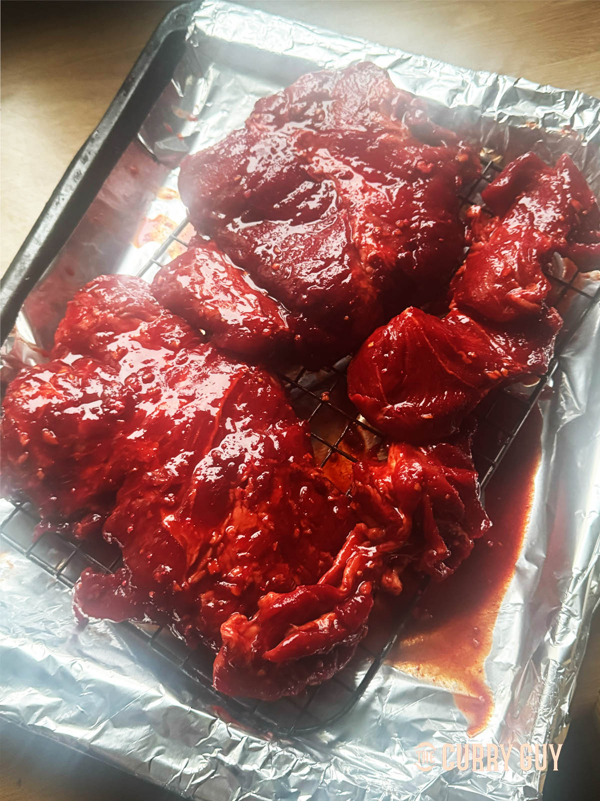The marinated pork on a wire rack ready for the oven.