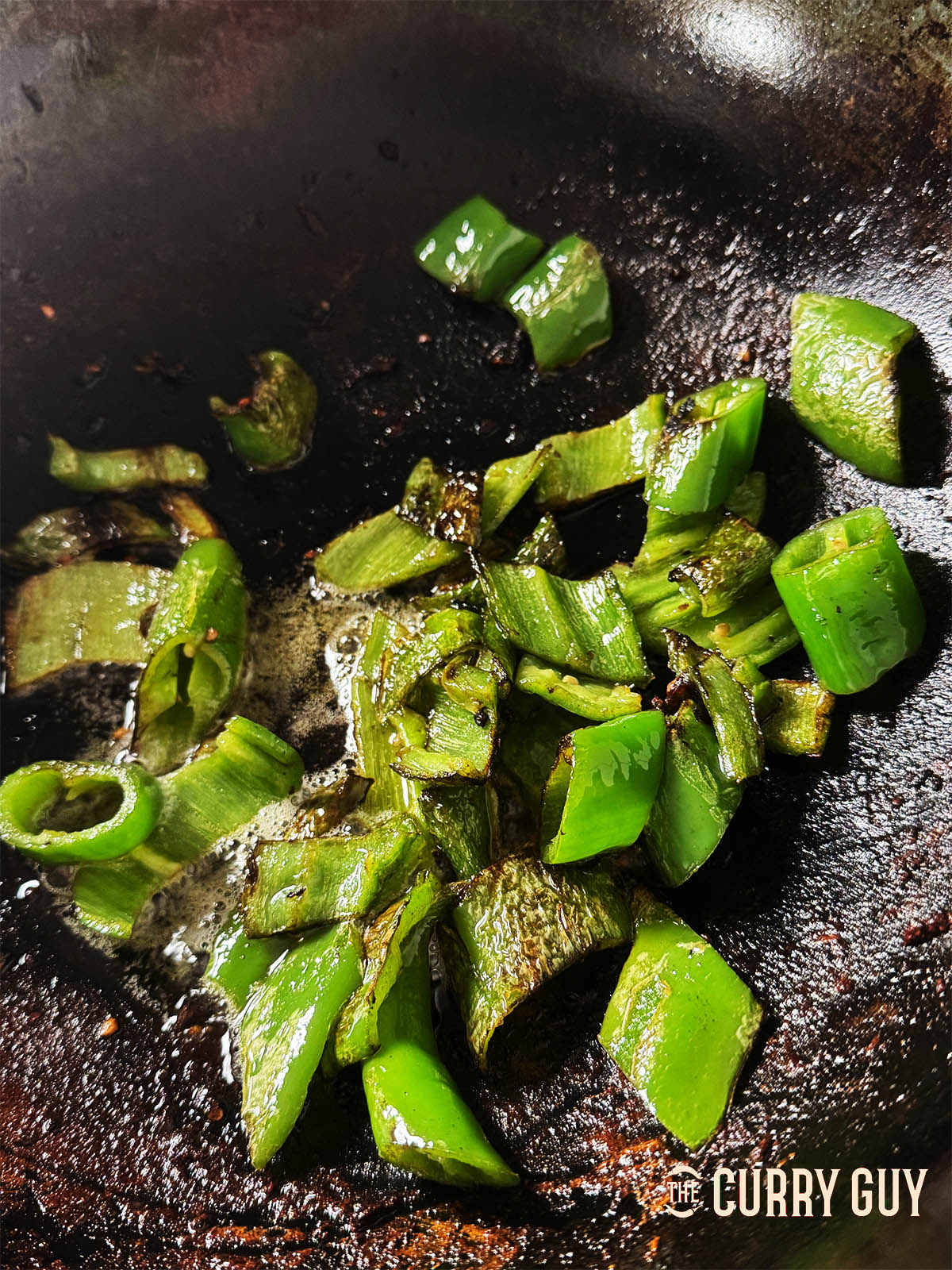 Frying the banana chillies to char slightly.