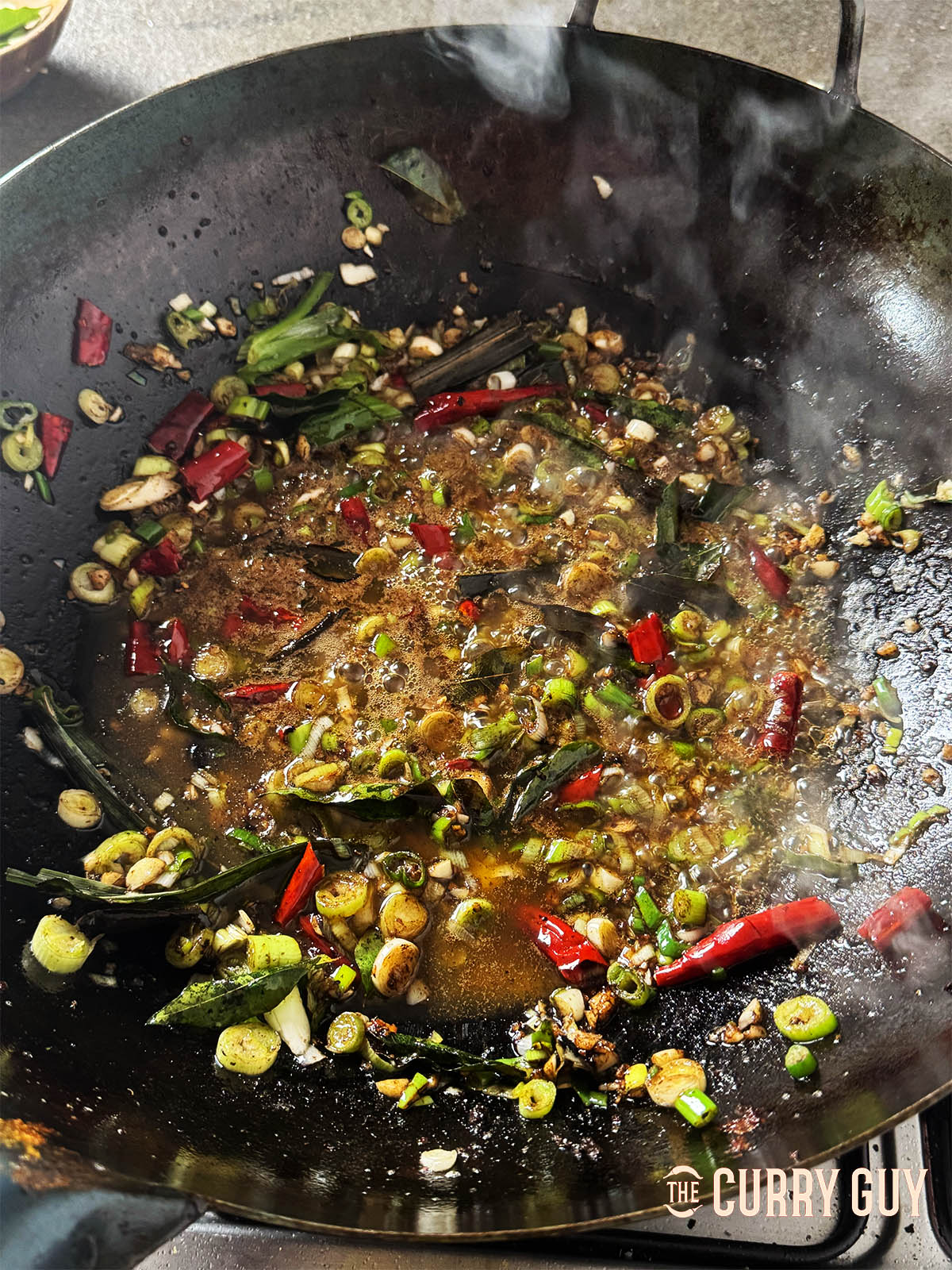 Gently frying the aromatic ingredients in butter.