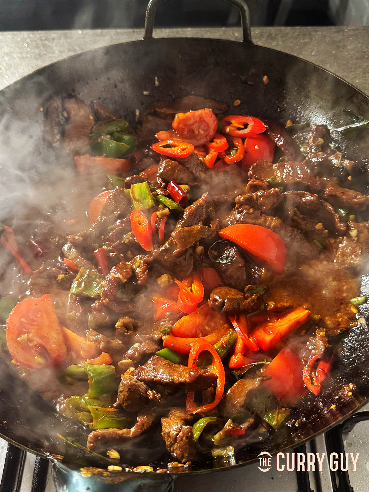 Simmering the curry in a wok.