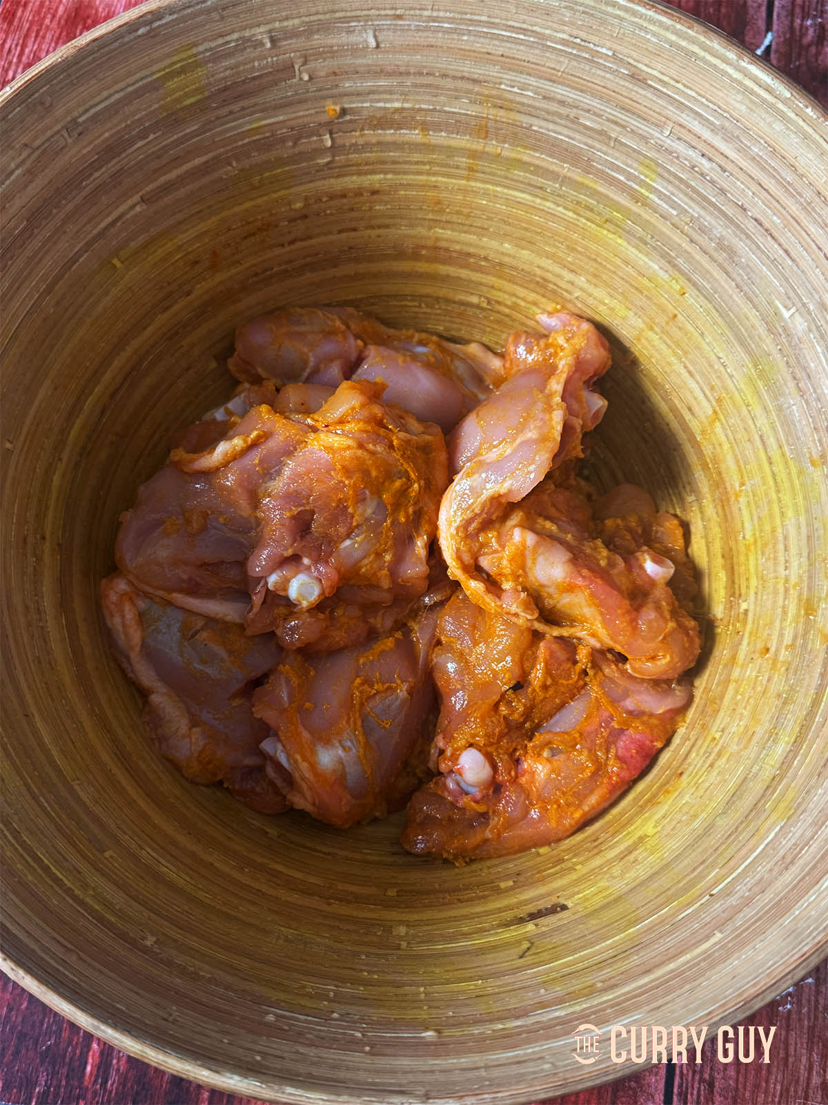 Marinating the chicken in the turmeric, salt and garlic and ginger paste. 