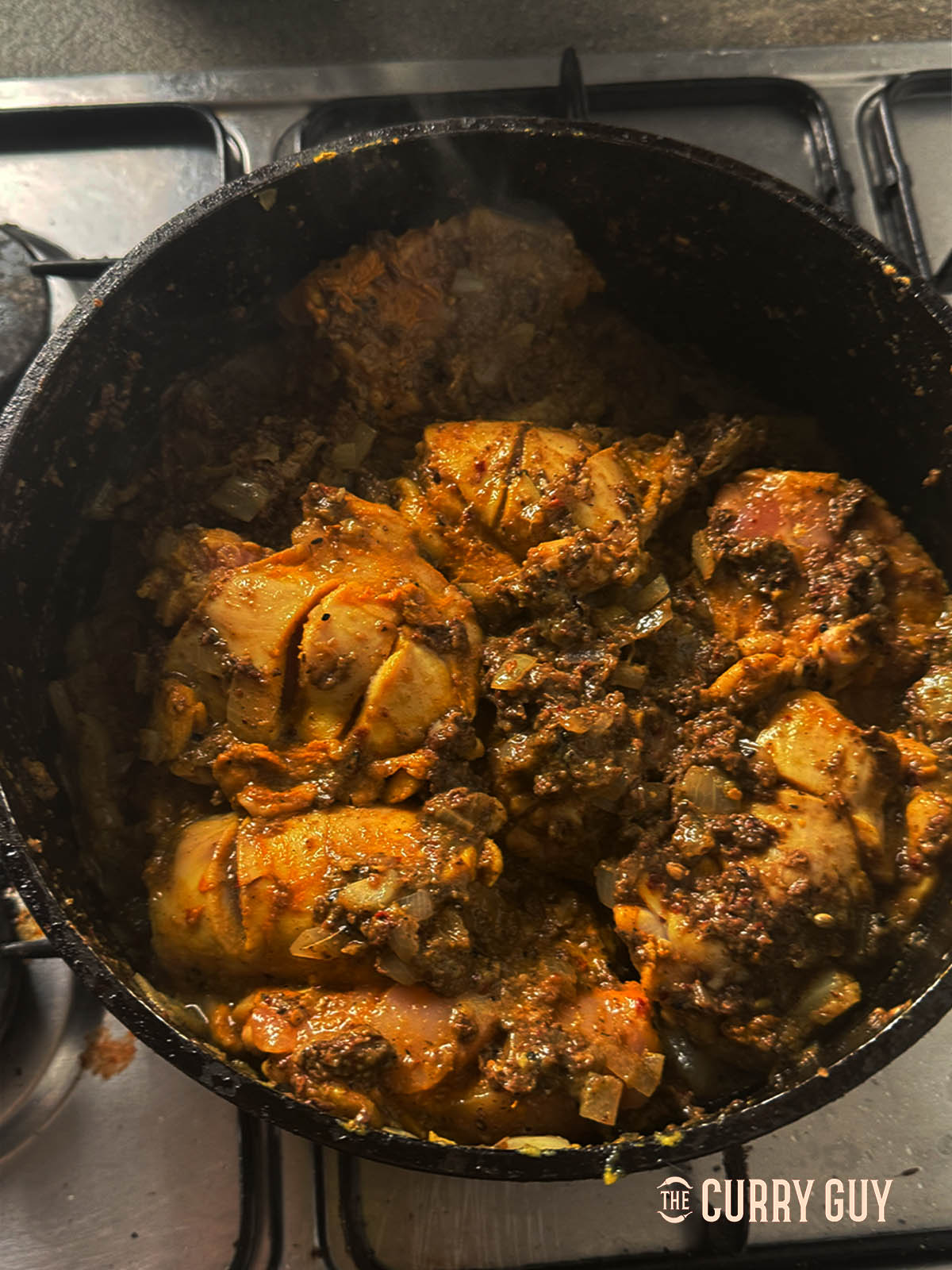 Adding the black curry paste to the chicken
