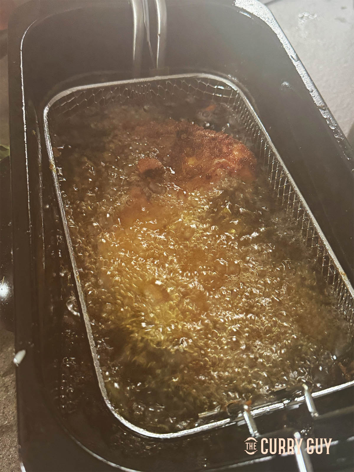 Frying the chicken in hot oil. 