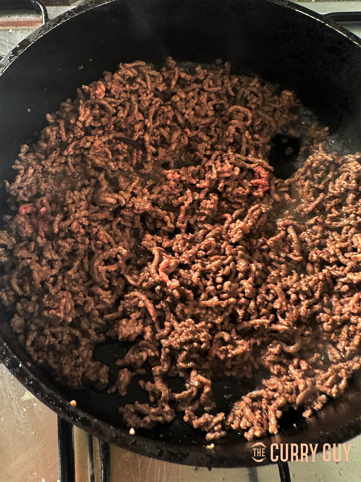 Frying the minced lamb in ghee.