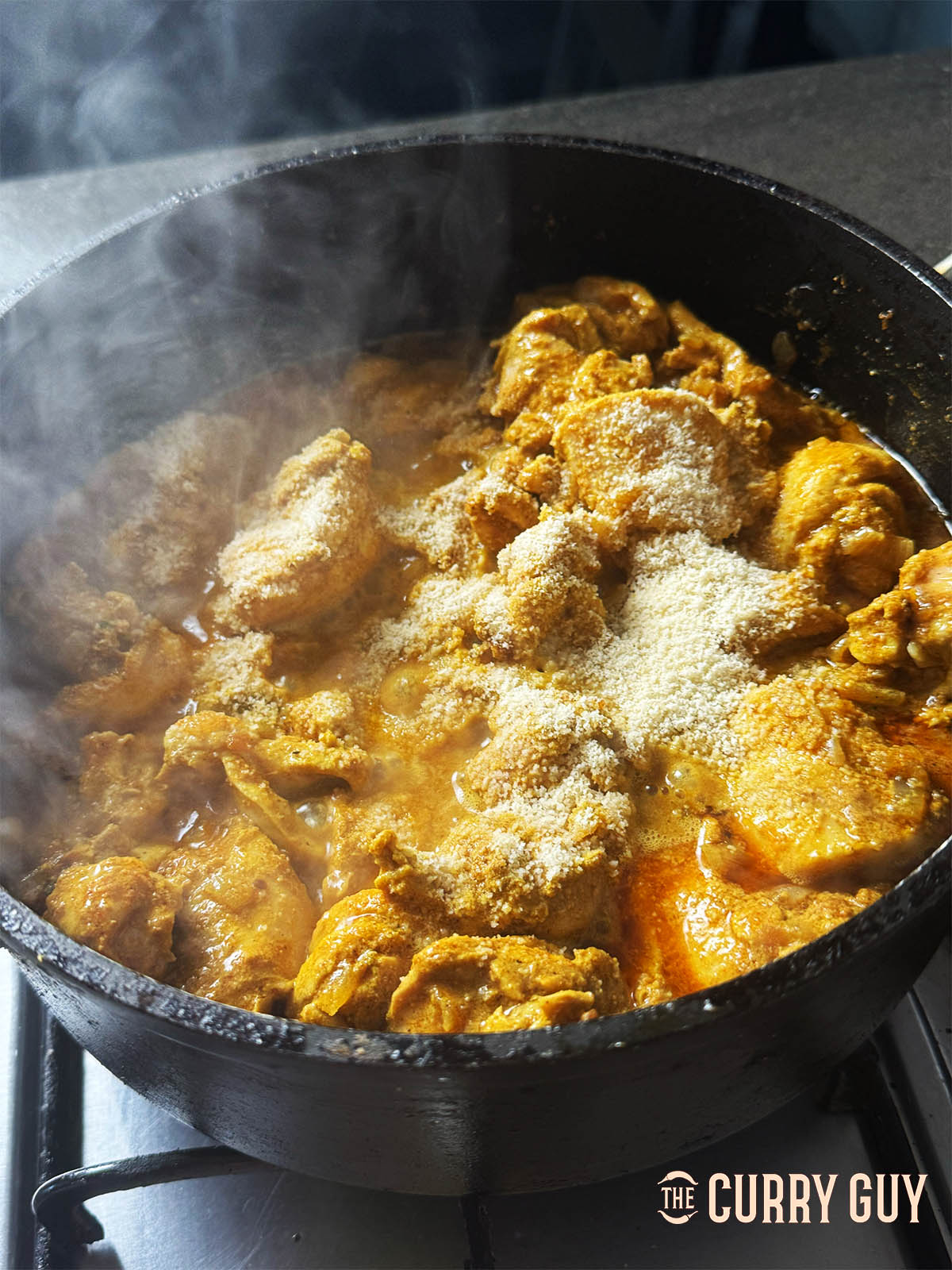 Stirring in the ground almonds and cooking into the sauce for a couple of minutes.