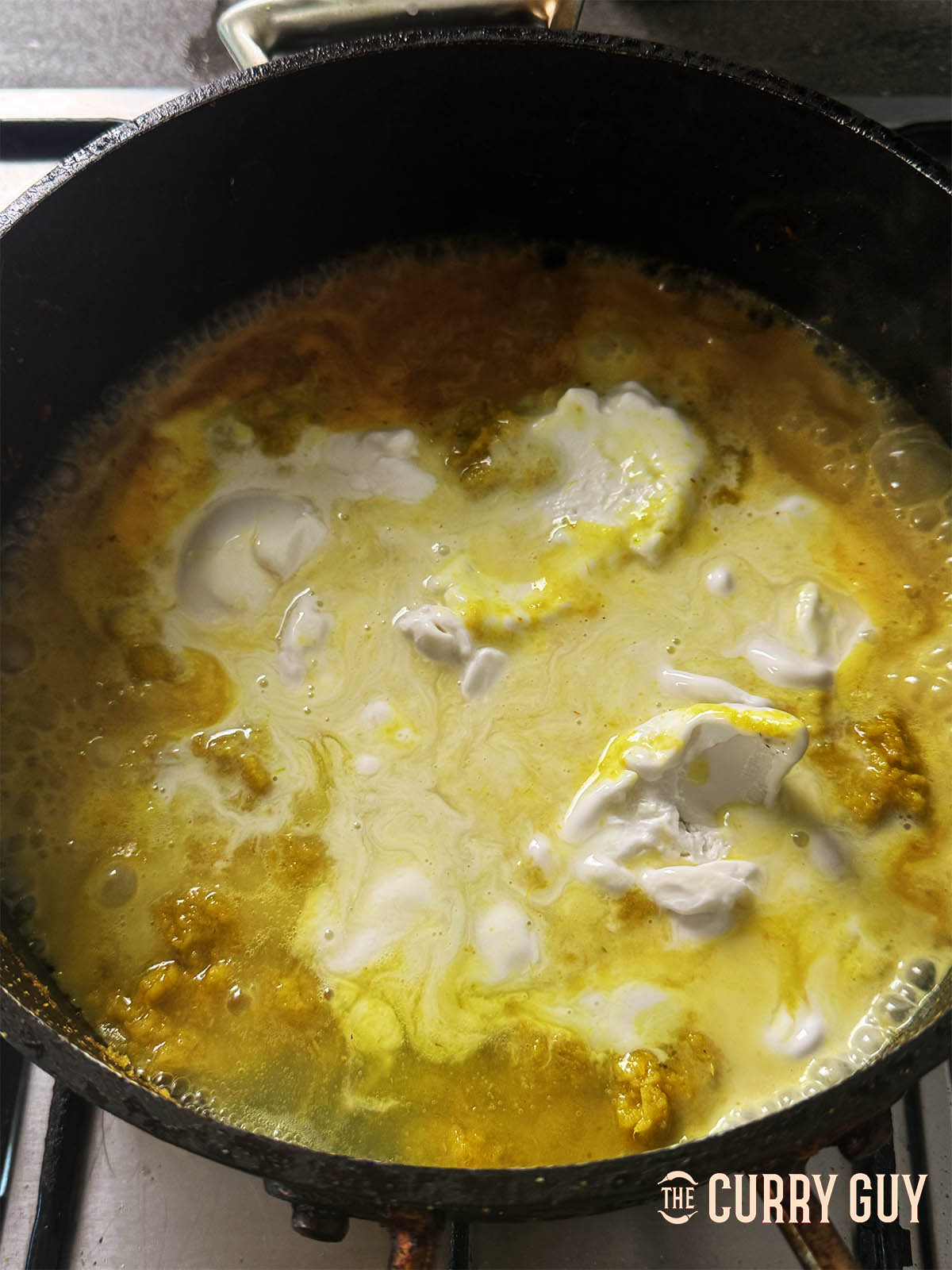 Adding some of the coconut milk to the pan.