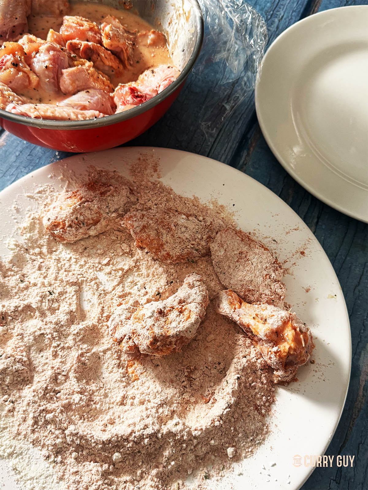 Coating the chicken wings with the flour mixture.
