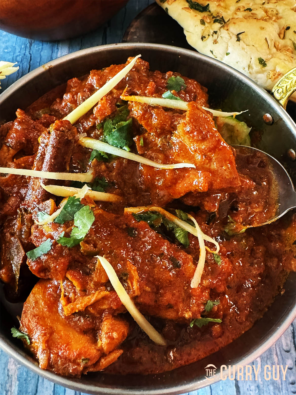 The finished chicken adrak curry topped with julienned ginger and chopped coriander.