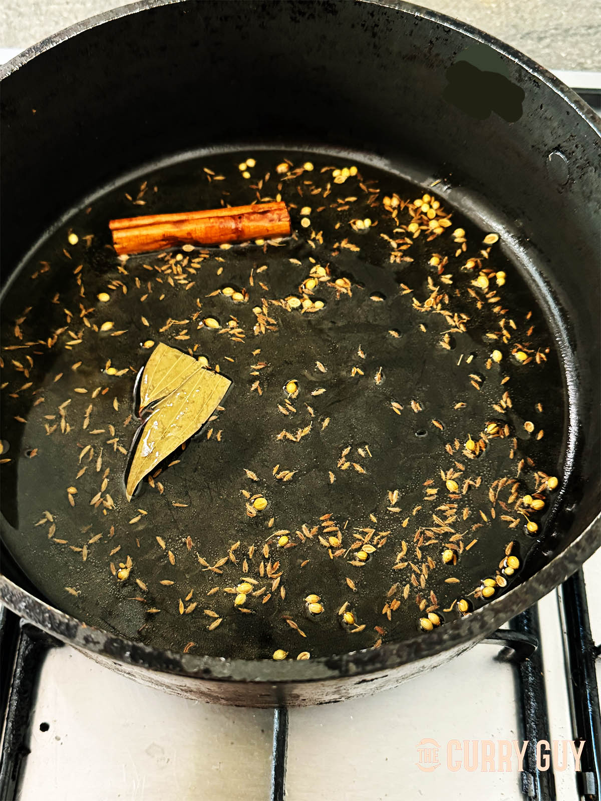 Infusing the spices into the hot oil for 30 to 60 seconds.