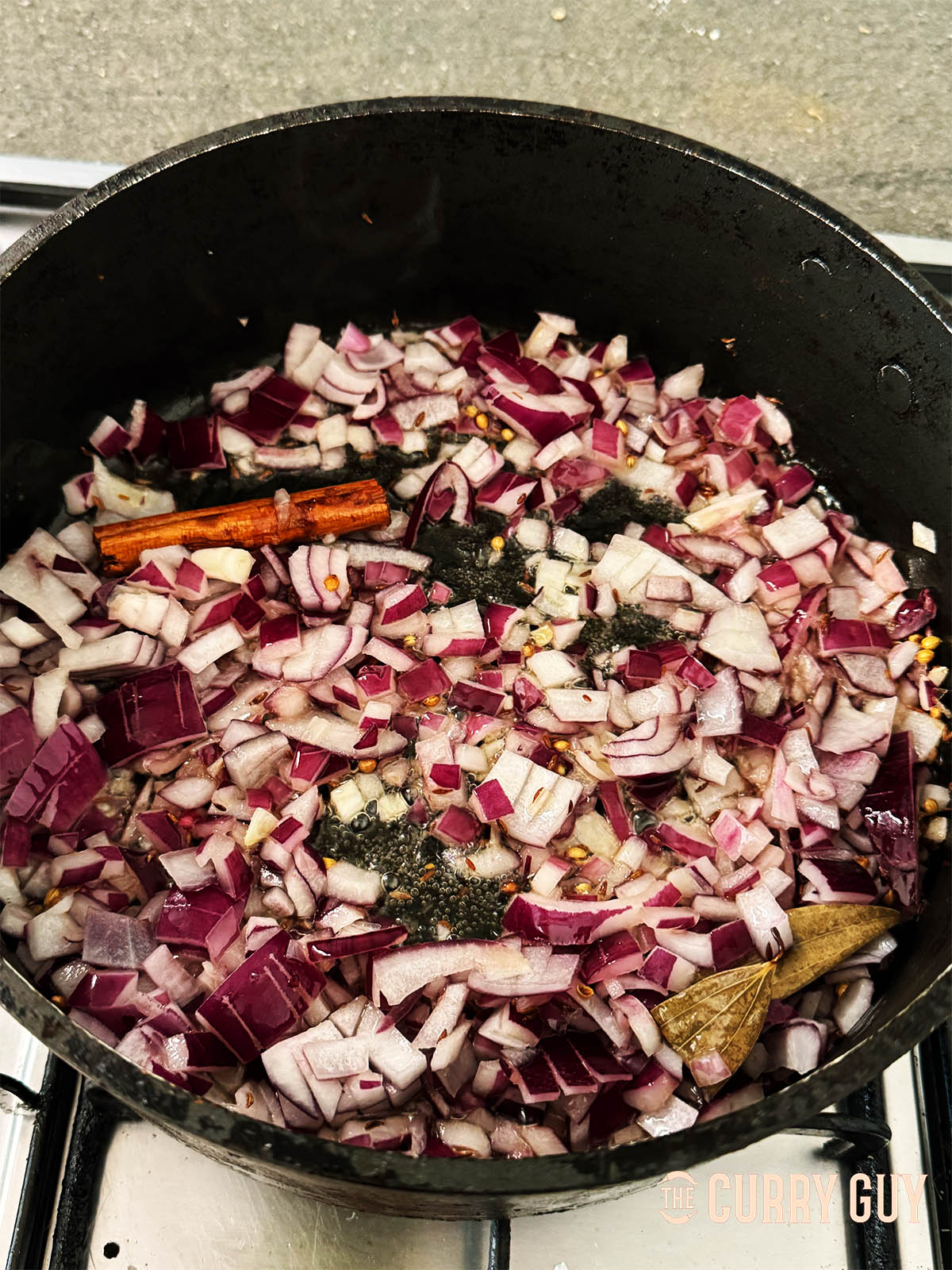Stirring in the chopped onions to fry for a good 10 to 20 minutes.
