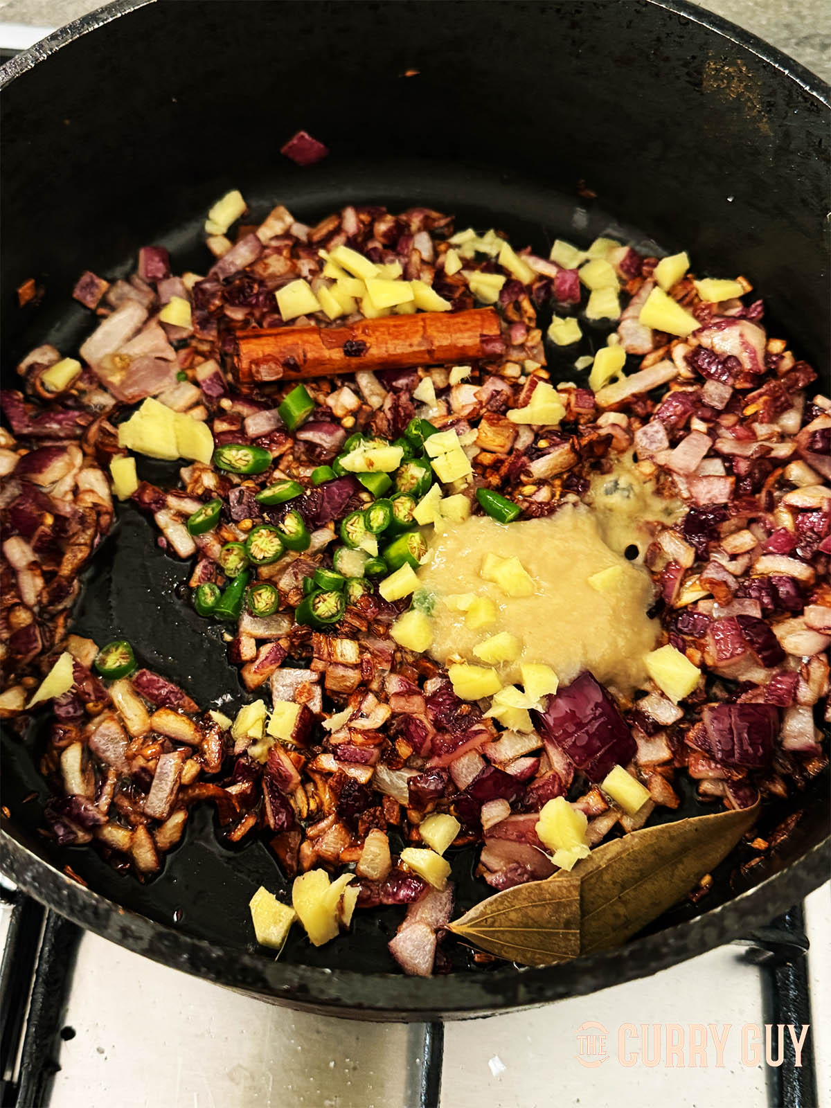 Stirring in the garlic and ginger paste along with the chopped chillies.