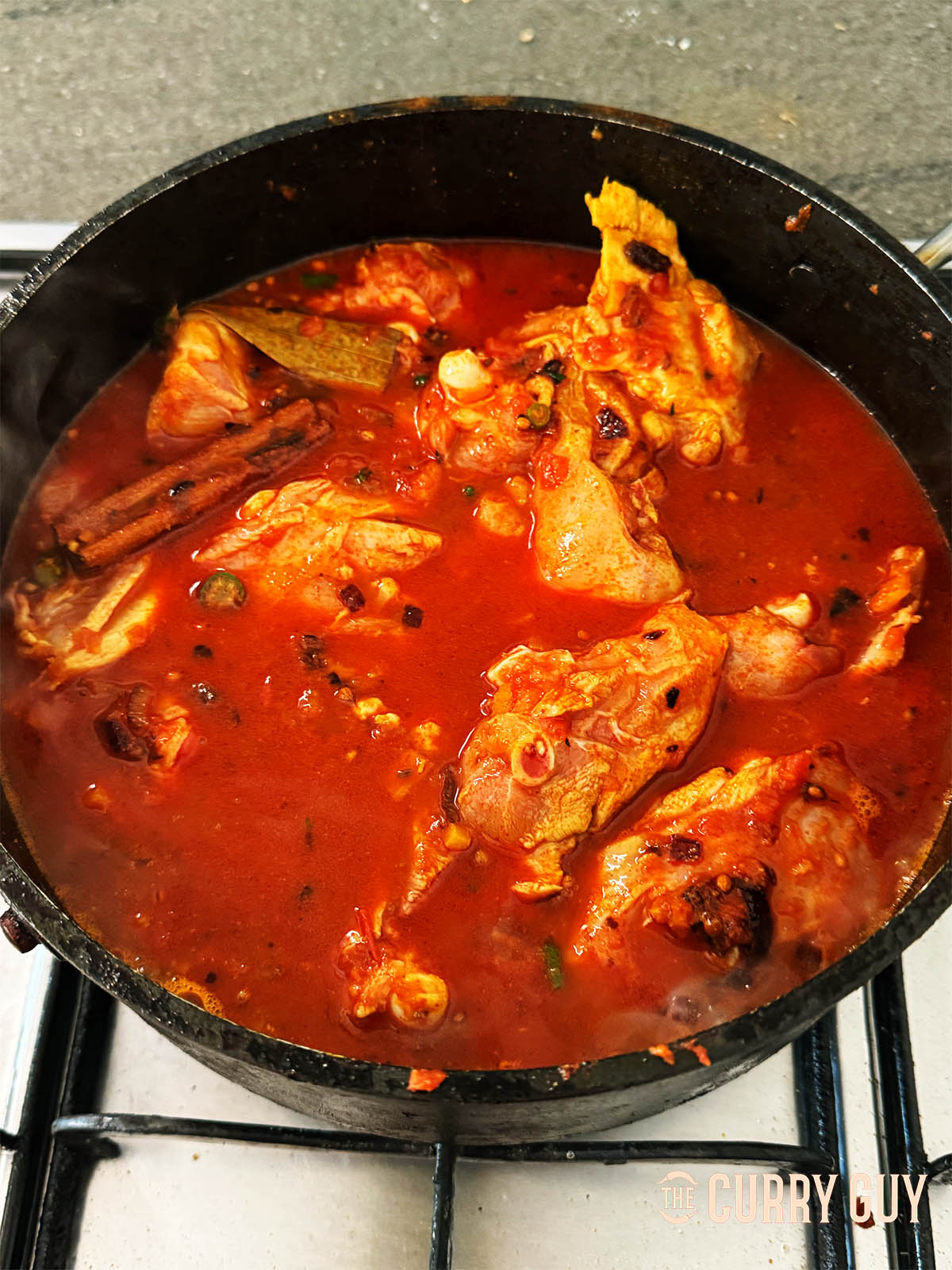 Adding the chicken and water or stock.