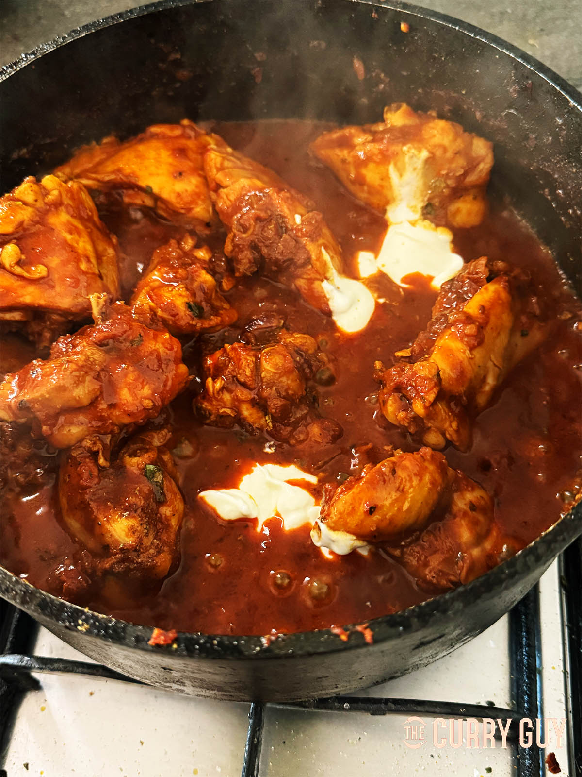 Simmering the sauce until thick and then adding the yoghurt.