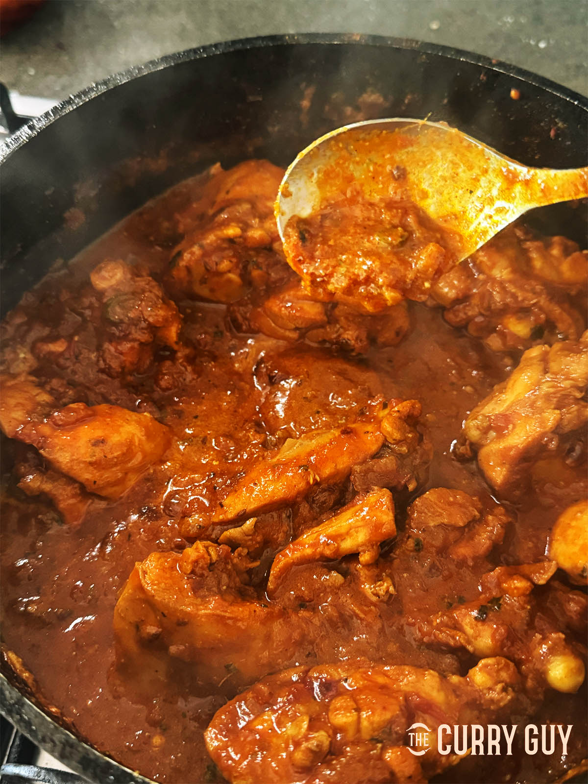 Seasoning and balancing the curry with lime juice and kasoori methi.