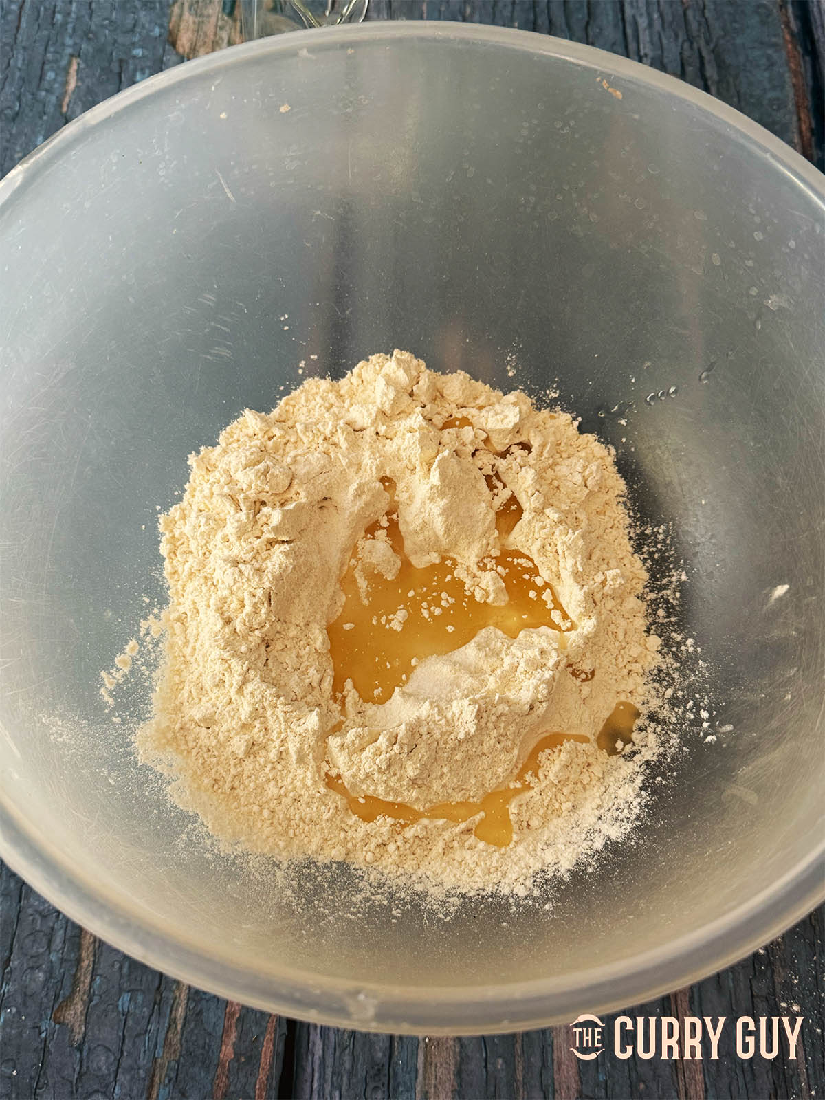 Adding the flour, salt and oil to a mixing bowl.