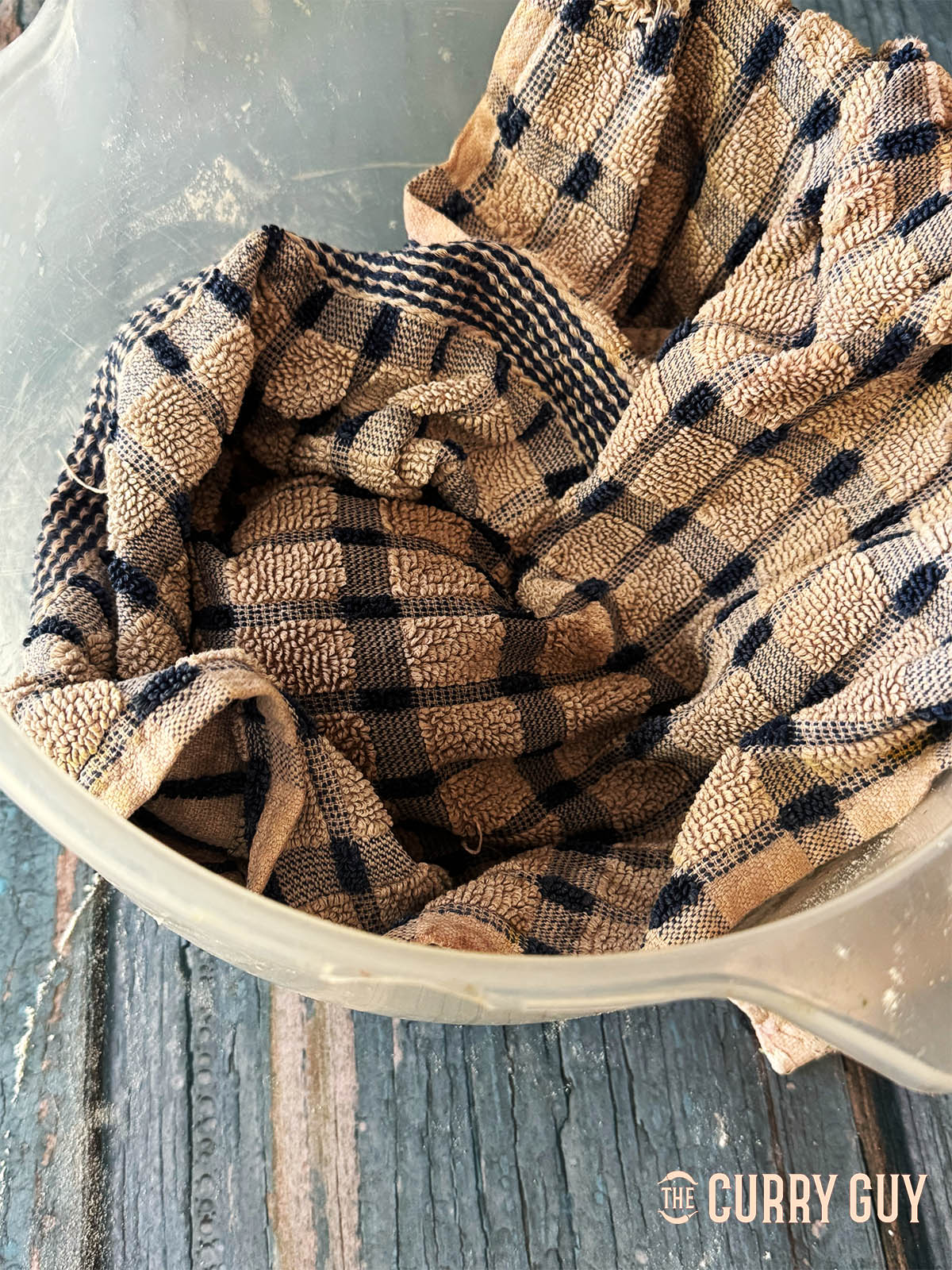 Covering the dough to rest before rolling.