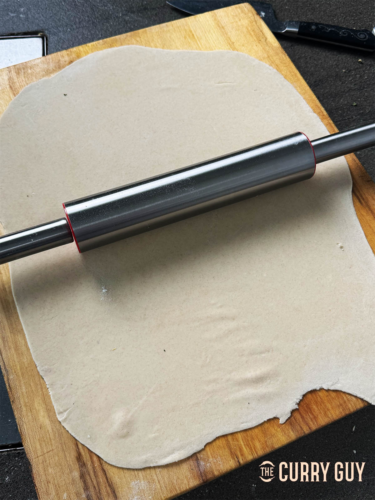 Rolling the dough out until it has a smooth surface but it not too thin.