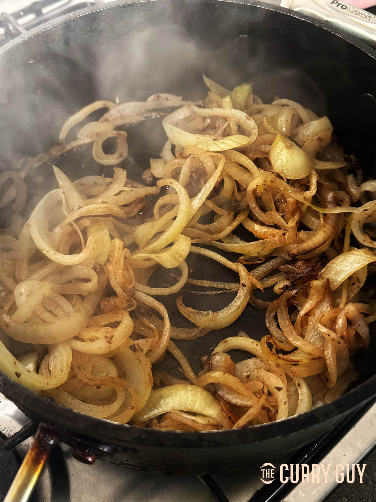Frying the onions until golden brown.