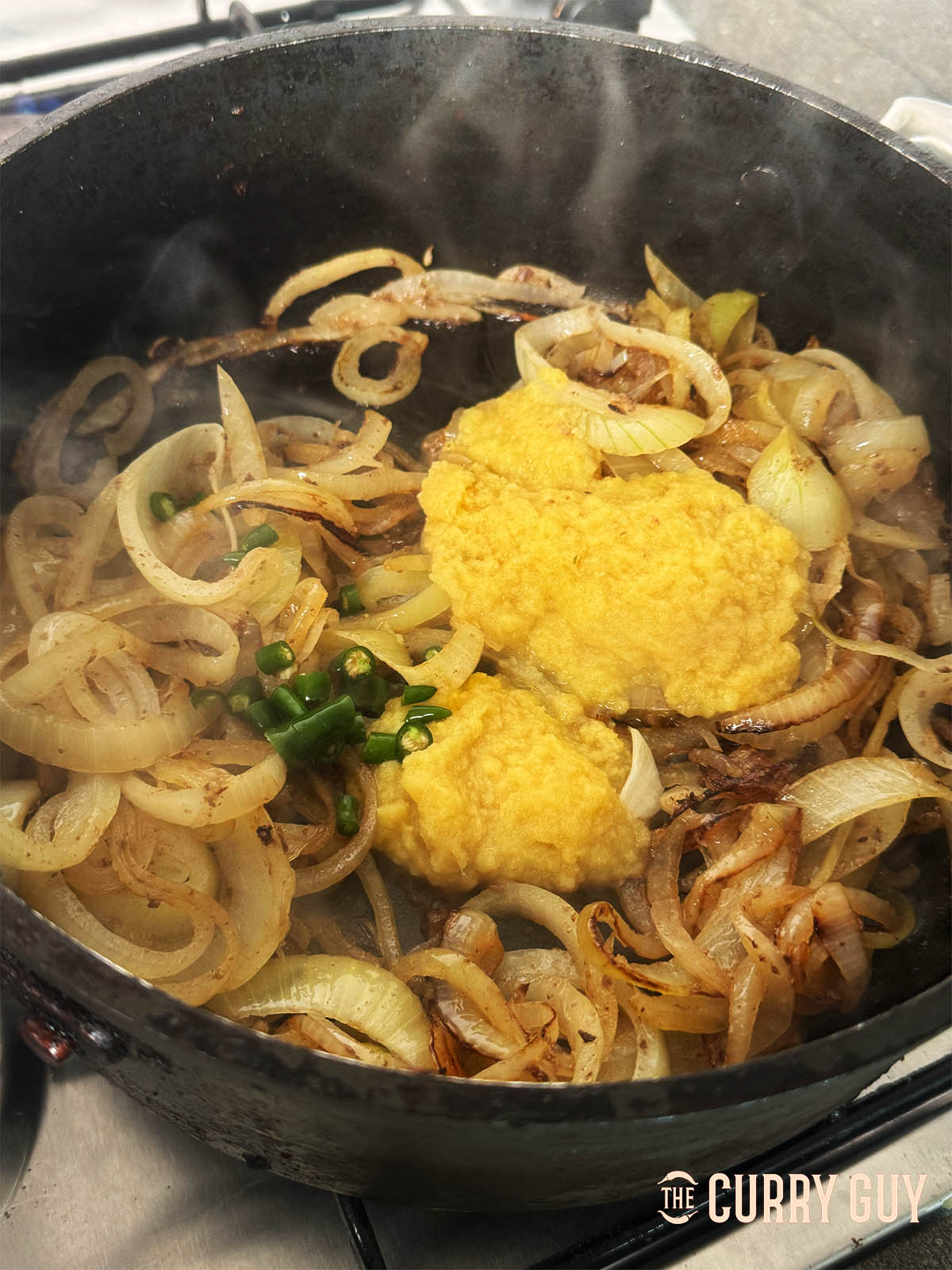 Adding the garlic and ginger paste along with the chopped chillies to the pan.