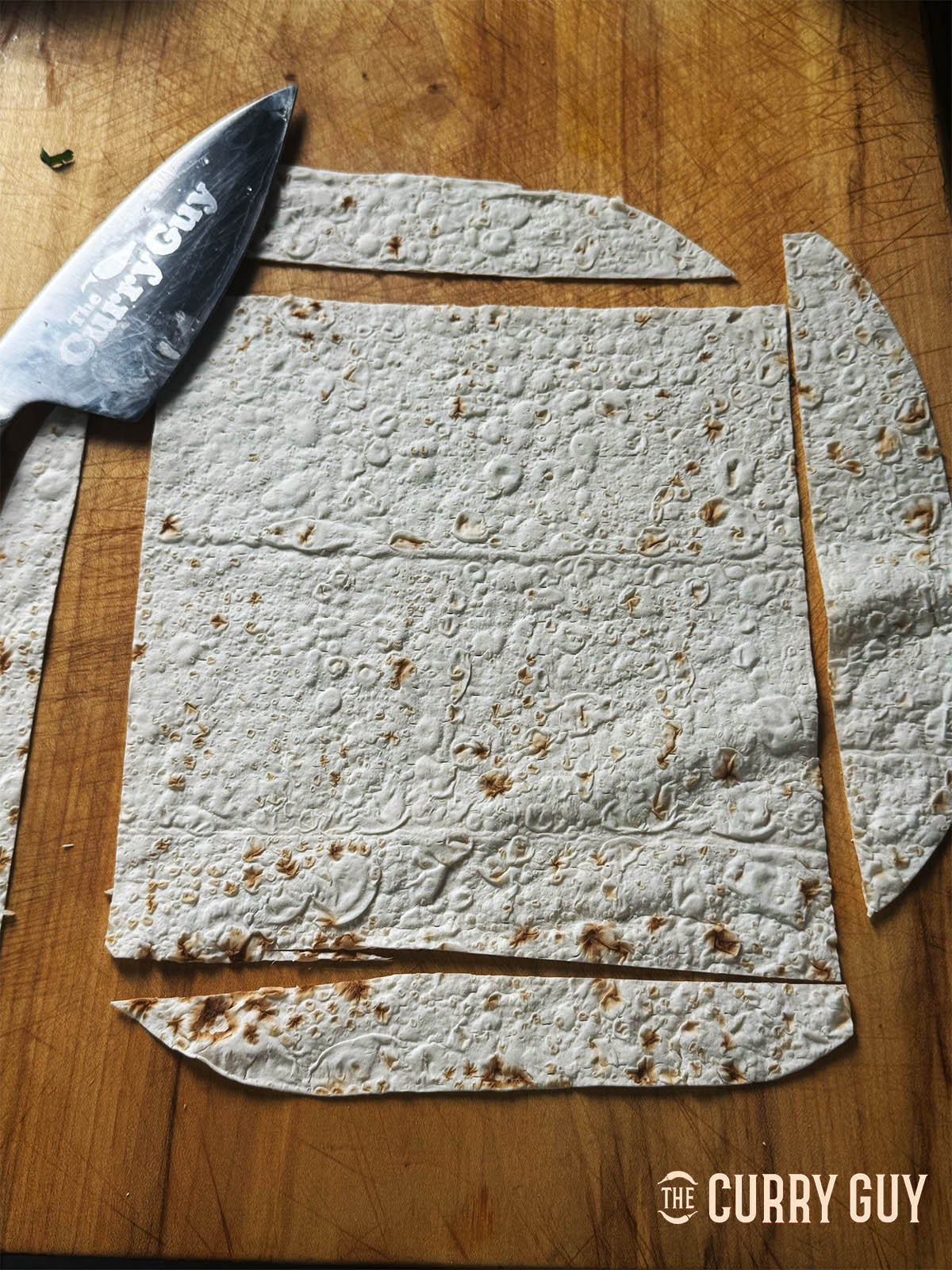 Slicing the round lavash into neat, equal sized squares