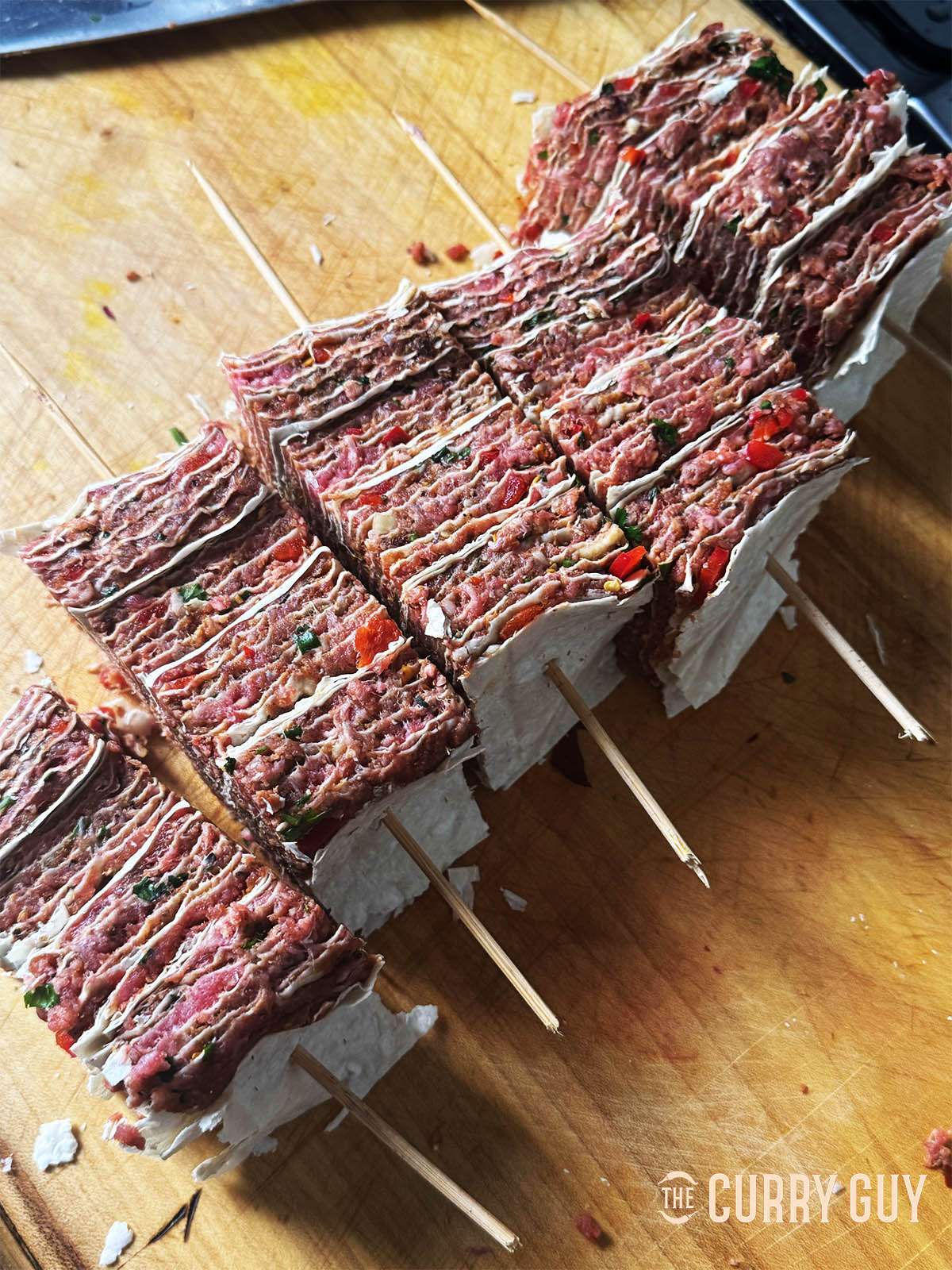 The lavash kebabs skewered and ready to fry or grill on your barbecue.