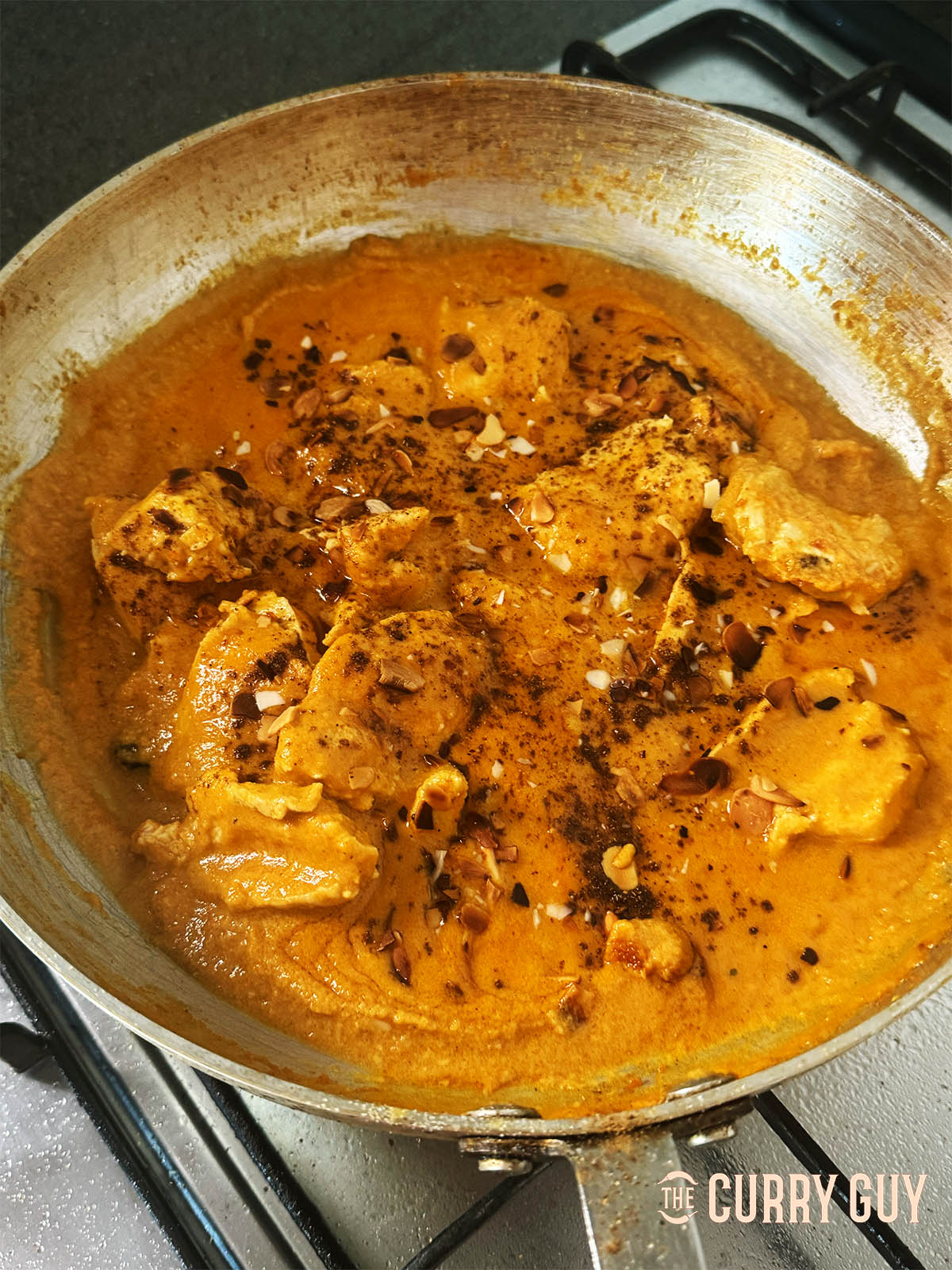Adding the garam masala to the curry.