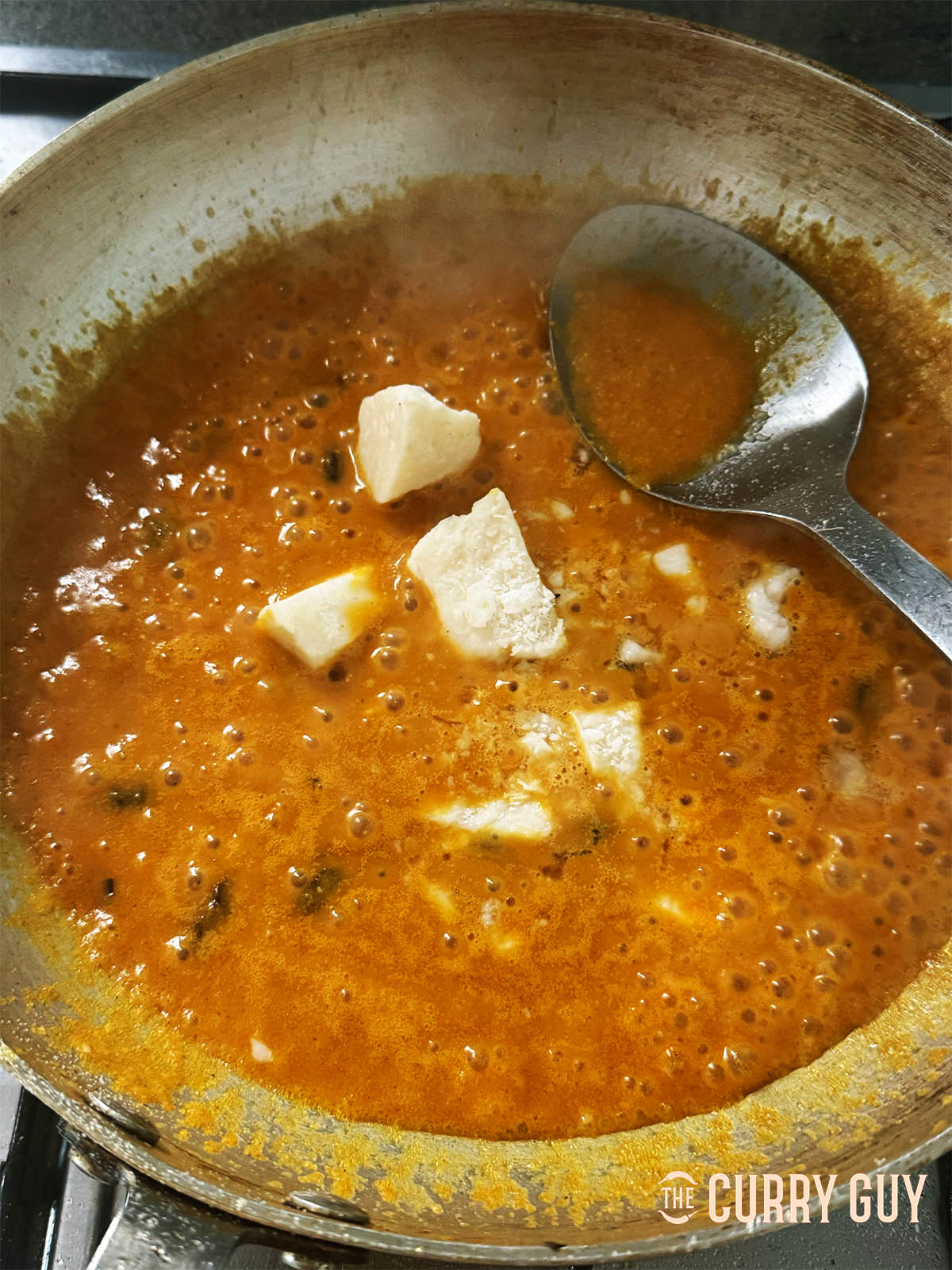 Adding a little base sauce and the block coconut to the pan.