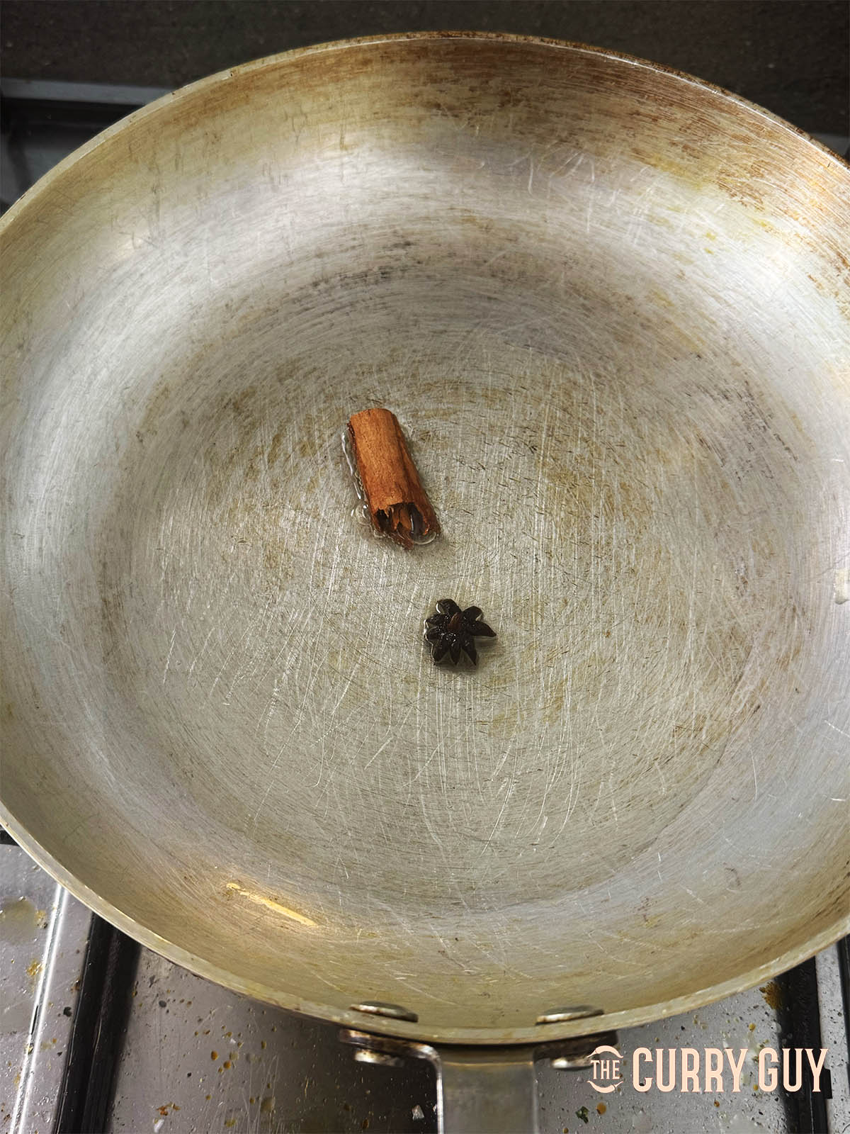 Infusing the cinnamon and star anise in the hot oil.