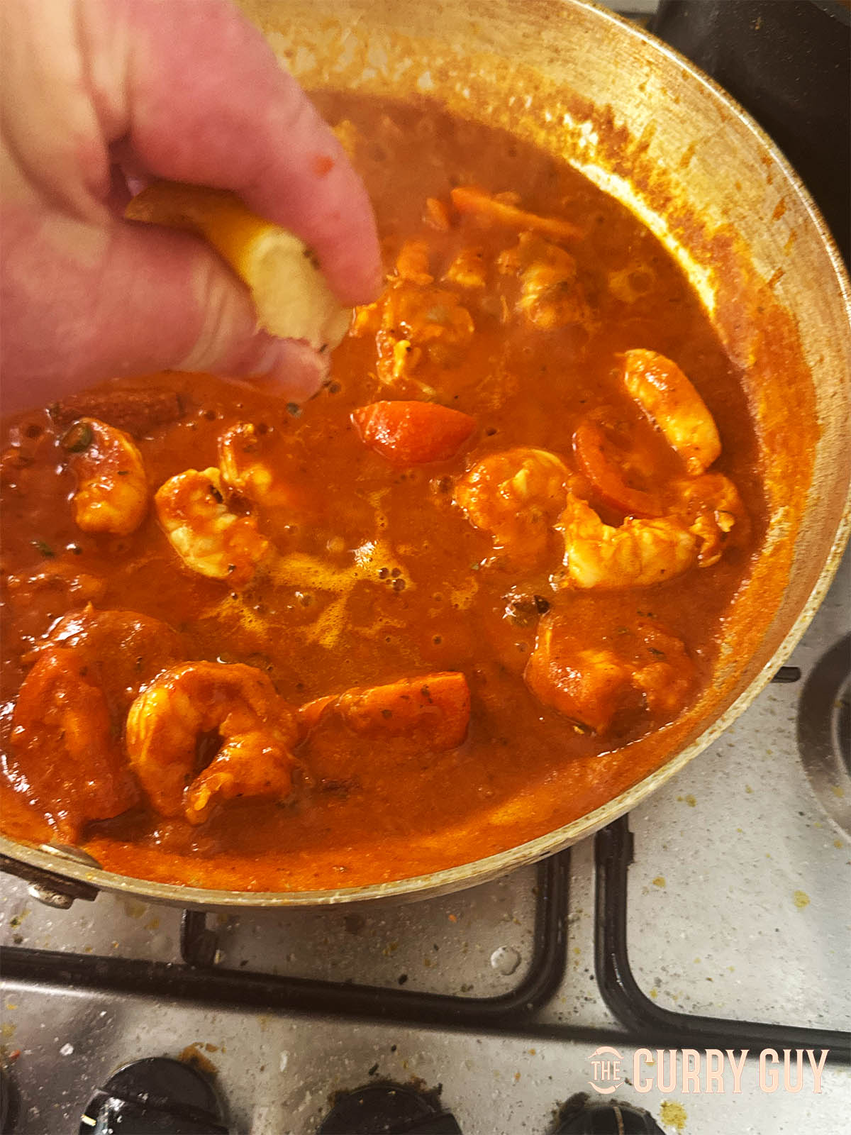 Adding salt and the lemon juice to the curry.