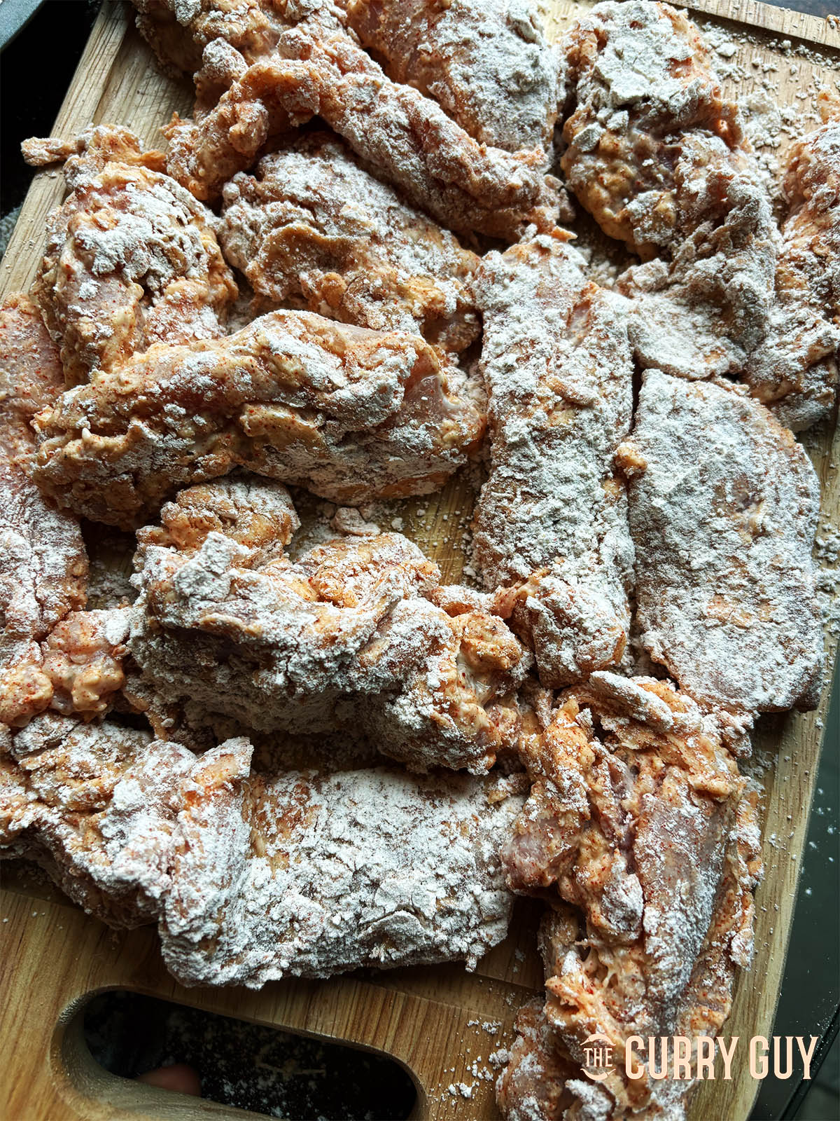 The flour coated chicken resting before frying.