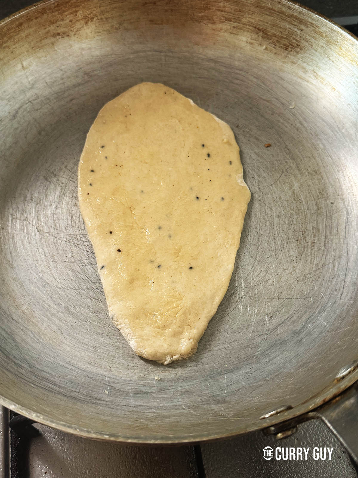 Pan frying a naan.