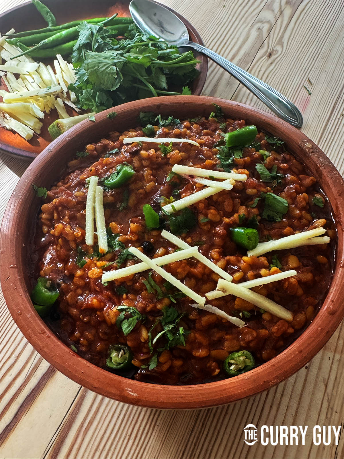 Urad daal mash garnished with julinenned ginger, chopped chillies and coriander.