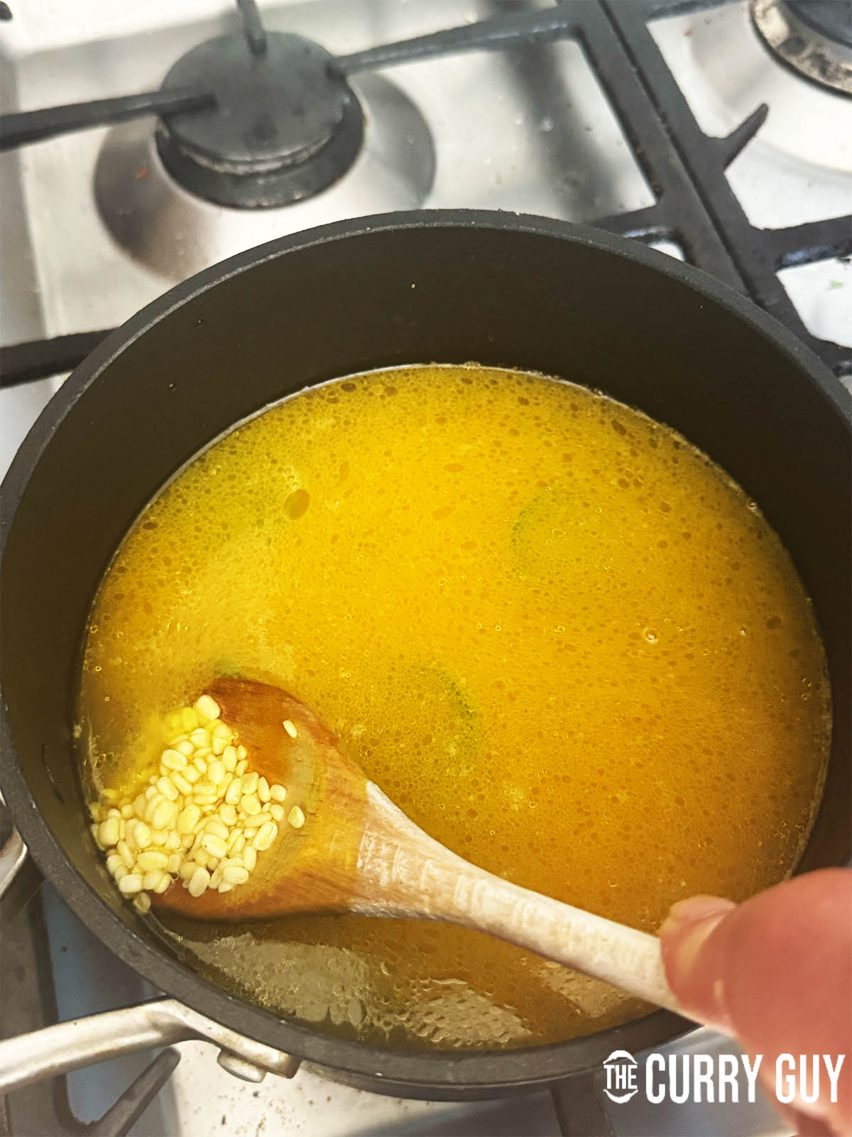Adding the lentils to the water.