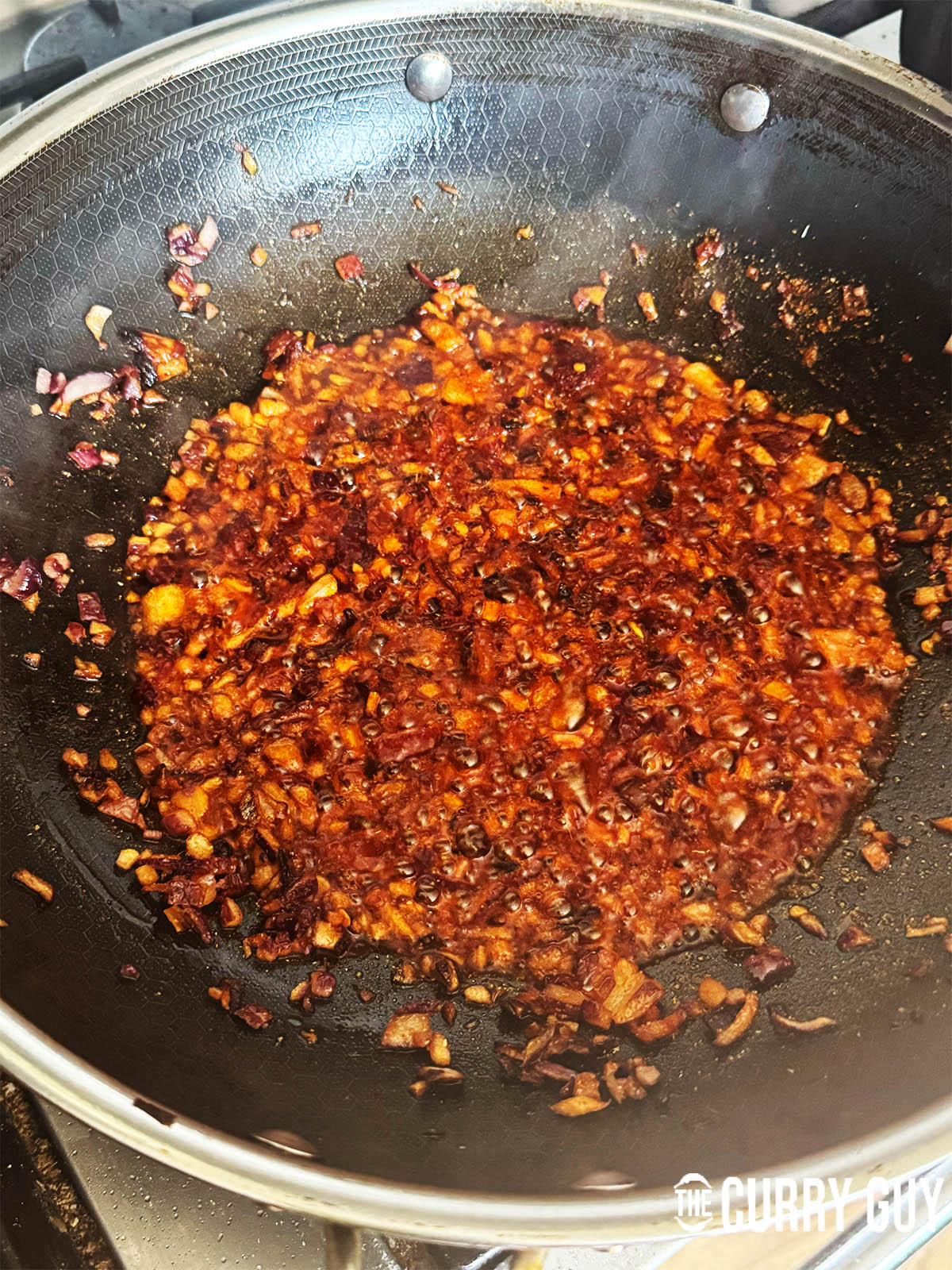 Adding the ground spices to the fried onions.