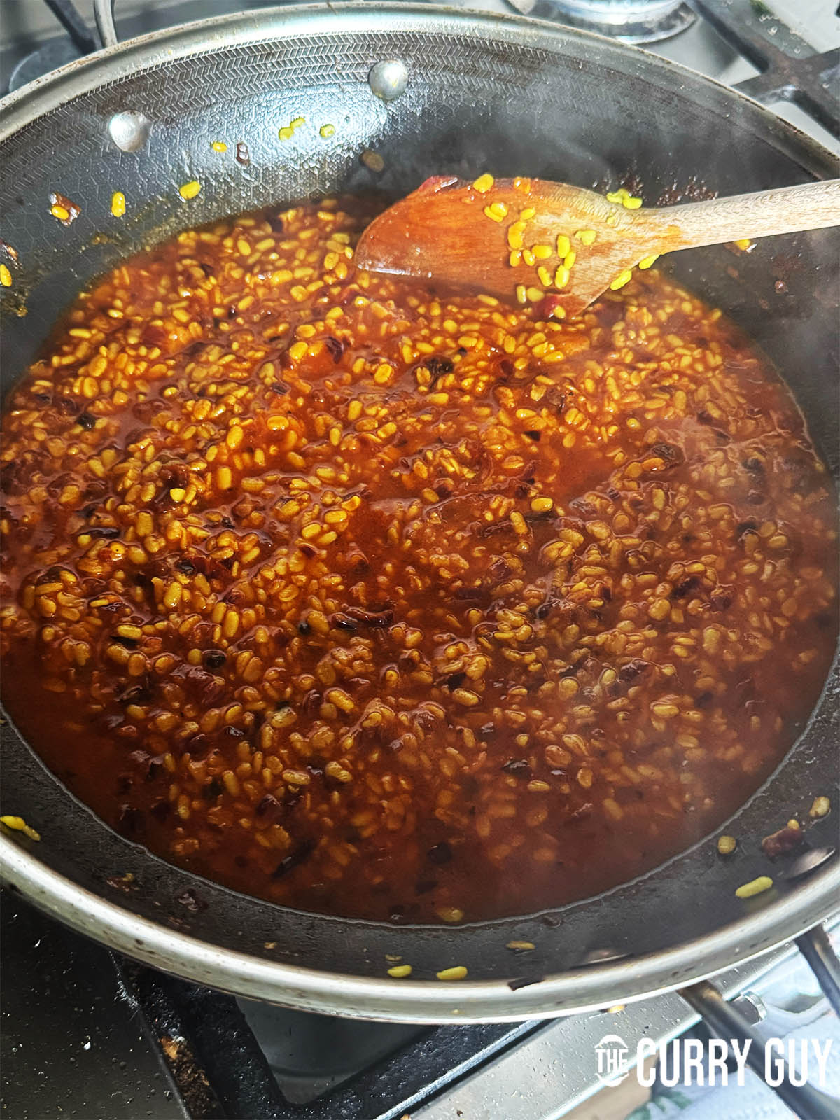 The urad daal mash just before seasoning with the ghee rising to the top.