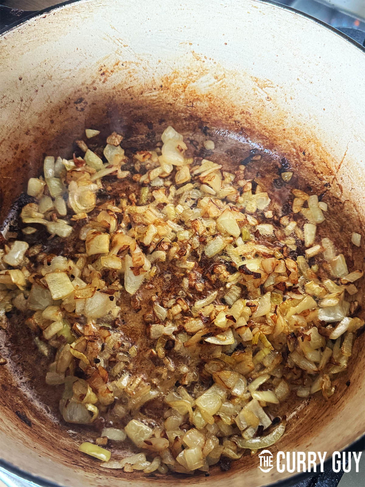 Frying the onions until soft and golden brown.