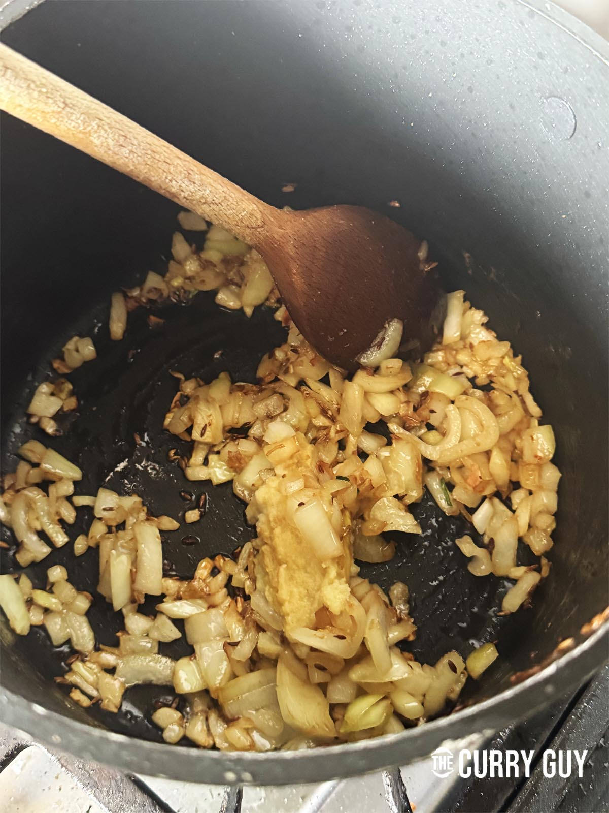 Frying onions in oil with cumin seeds
